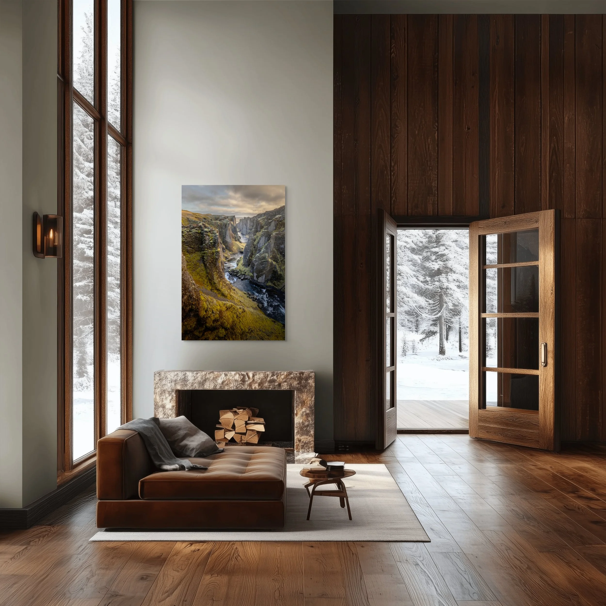 Living room with large window and open door showing snow-covered outdoor landscape, leather sofa, fireplace, landscape painting, wooden floors and walls.