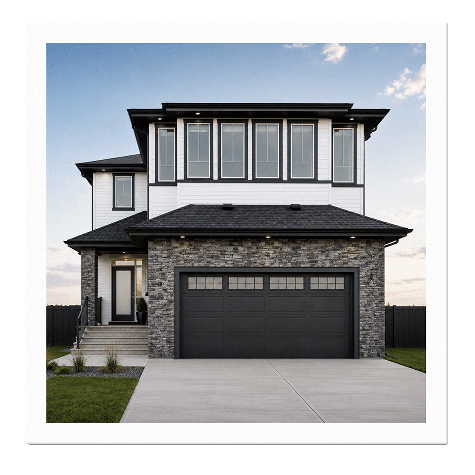 Modern two-story house with a stone and white exterior, large windows, and a black garage door. Green lawn and concrete driveway in front, with a small staircase leading to the front door.