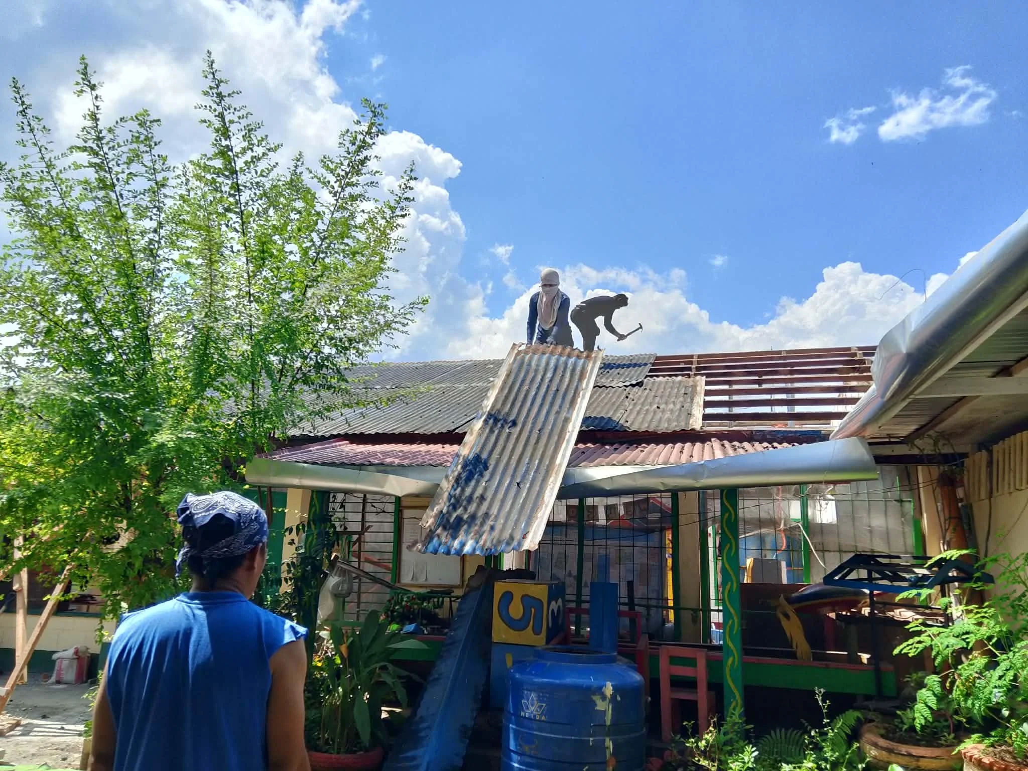 Community members use carpentry skills to rebuild Pagasinan school.jpg