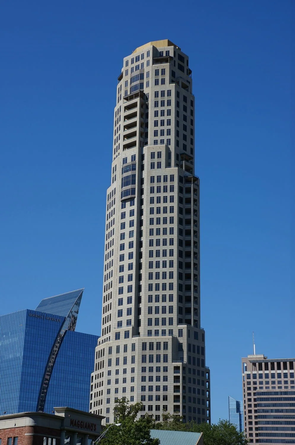 A skyscraper with multifamily apartments against a blue sky