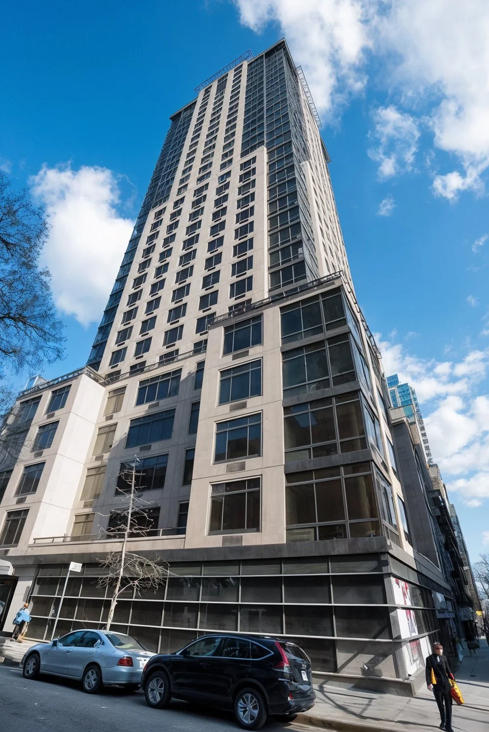 Looking up at a skyscraper against a blue sky