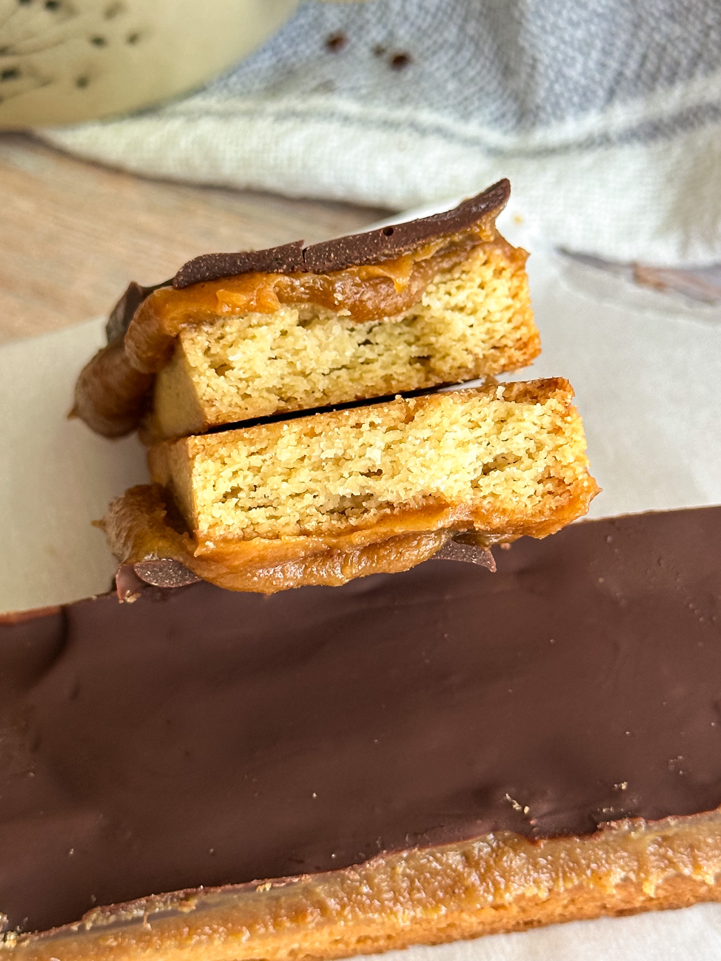 sliced gluten-free Twix bars showing caramel and chocolate layers