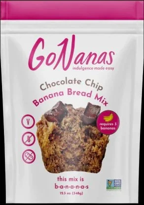 Package of GoNanas Banana Bread Mix with chocolate chip flavor, showing a picture of a banana bread muffin with chocolate pieces, and icons indicating it is vegan, gluten-free, and nut-free.