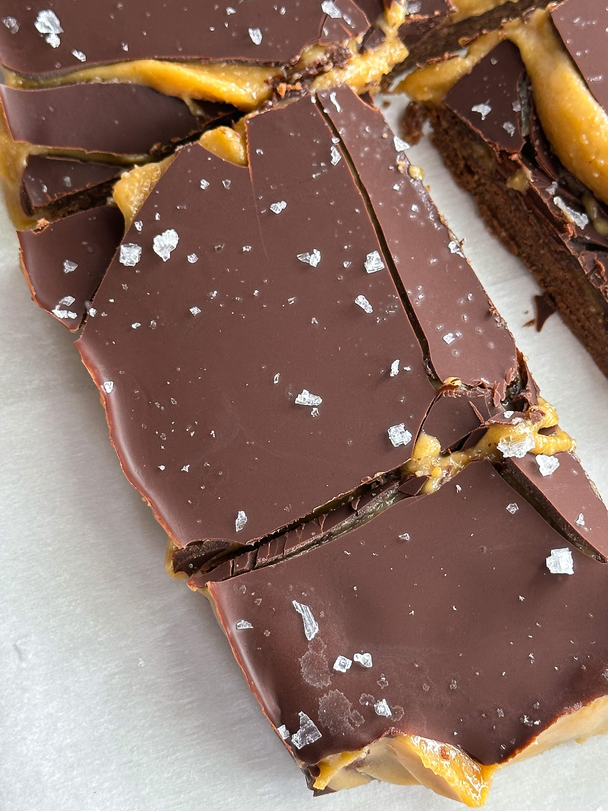 A vegan twist on Twix bars, made with almond flour, coconut oil, and maple syrup, layered into a decadent, chewy, and crisp treat that satisfies sweet cravings while staying refined sugar free