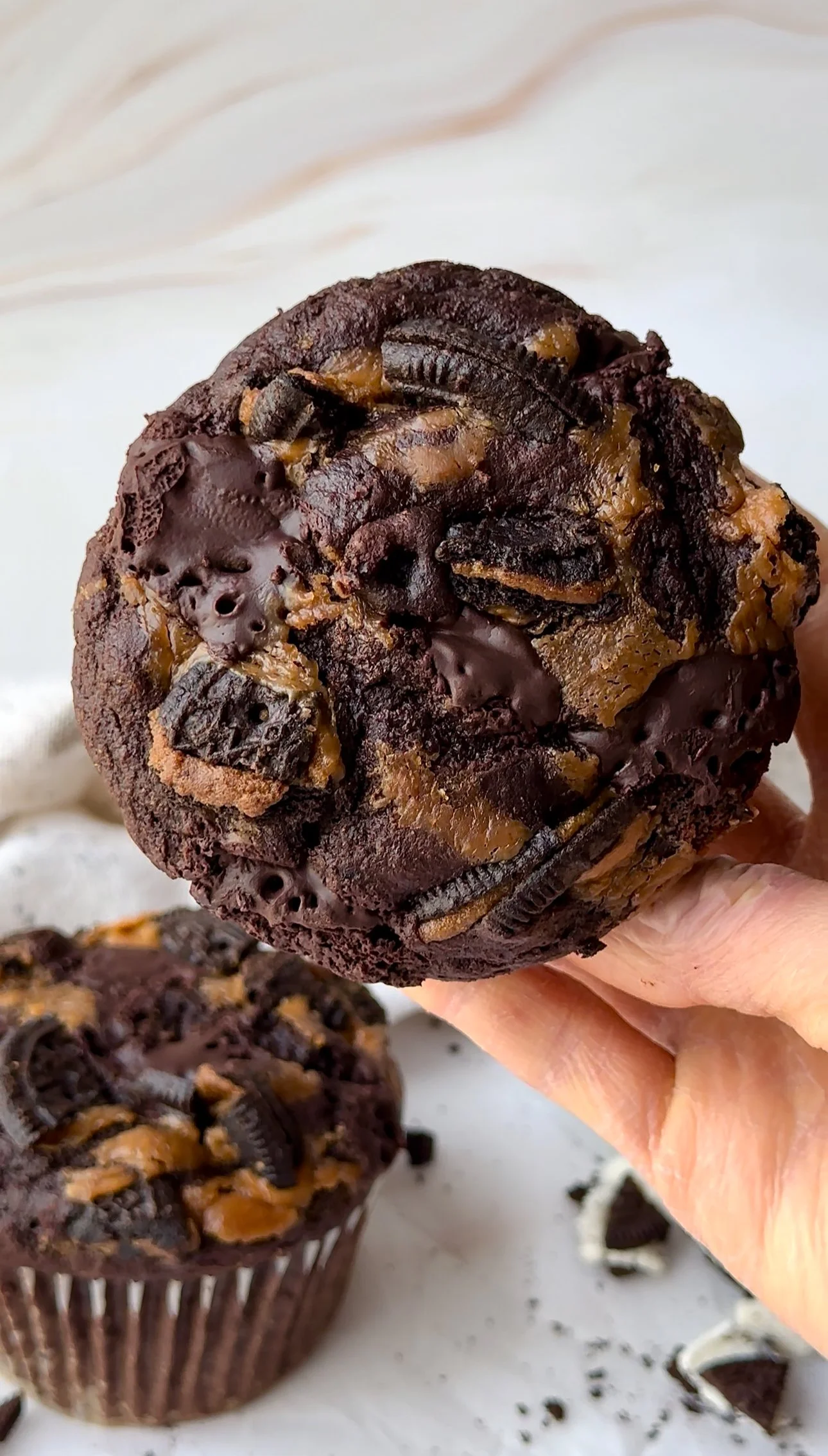 Close-up of muffin with gooey peanut butter swirl and crushed chocolate cookies