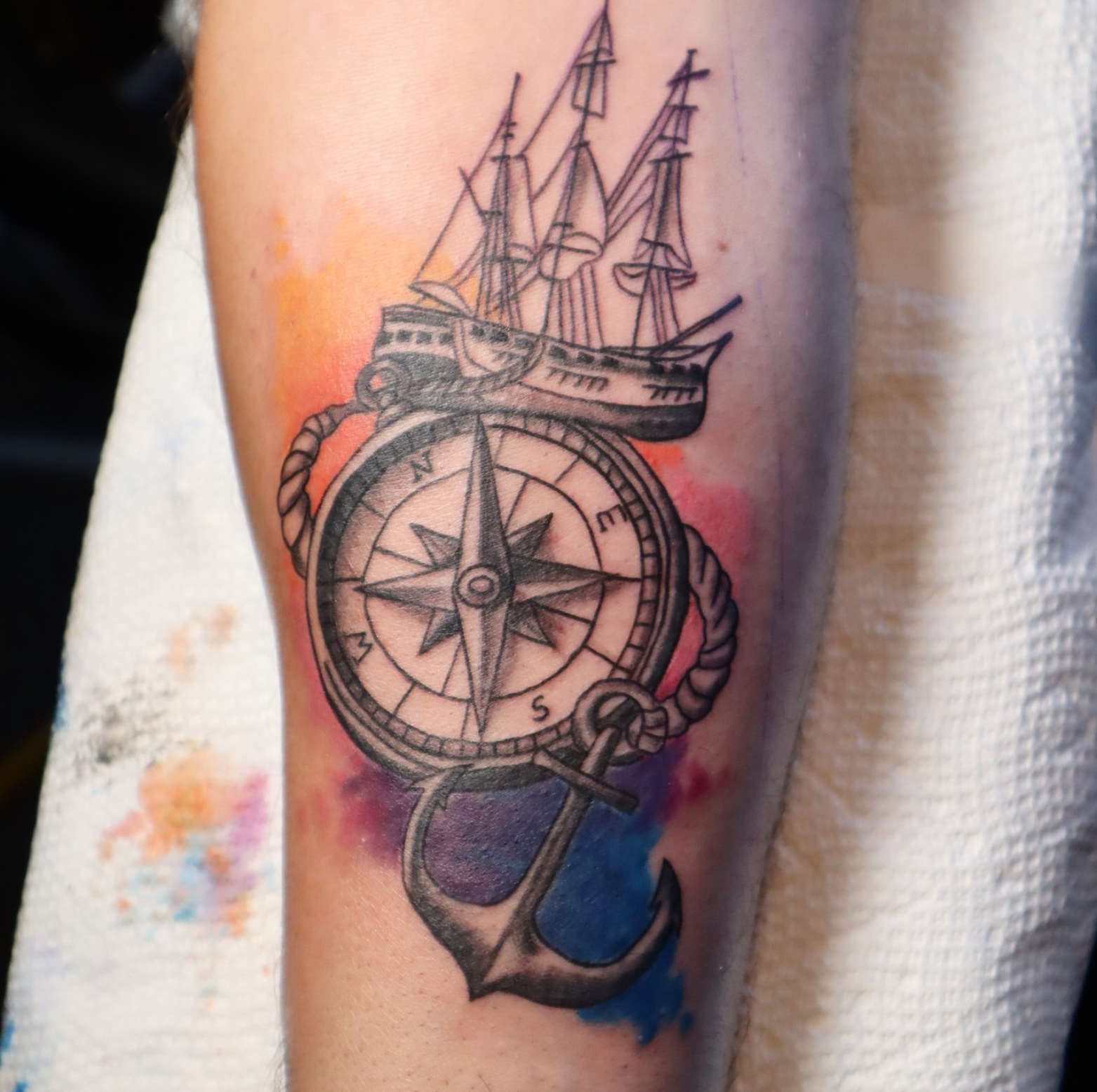 Watercolour Ship and Compass tattoo by tattoo artist Willow Thomason located in Wolfville, Nova Scotia