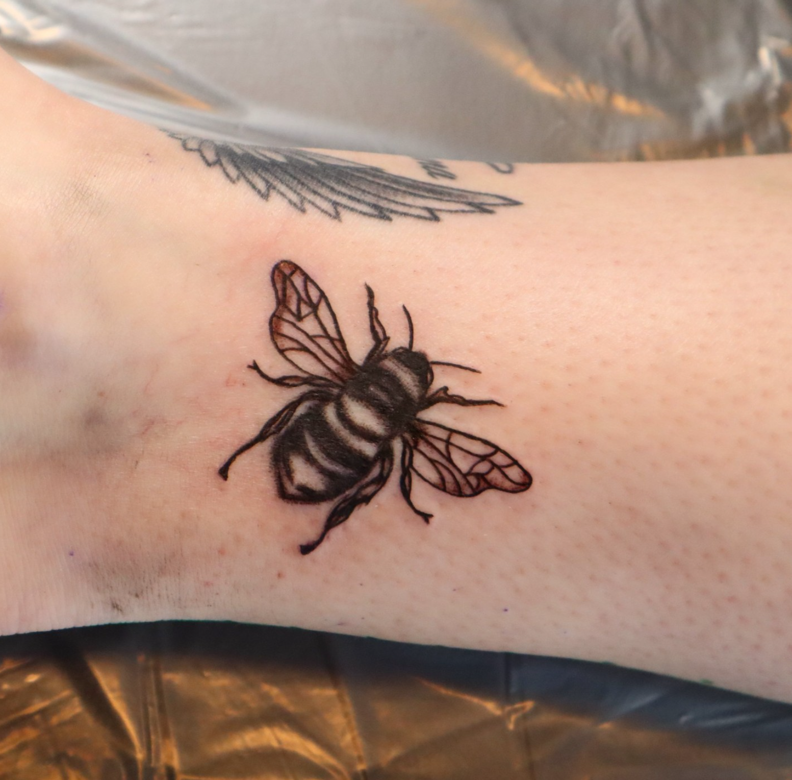 Bee tattoo by tattoo artist Willow Thomason located in Wolfville, Nova Scotia