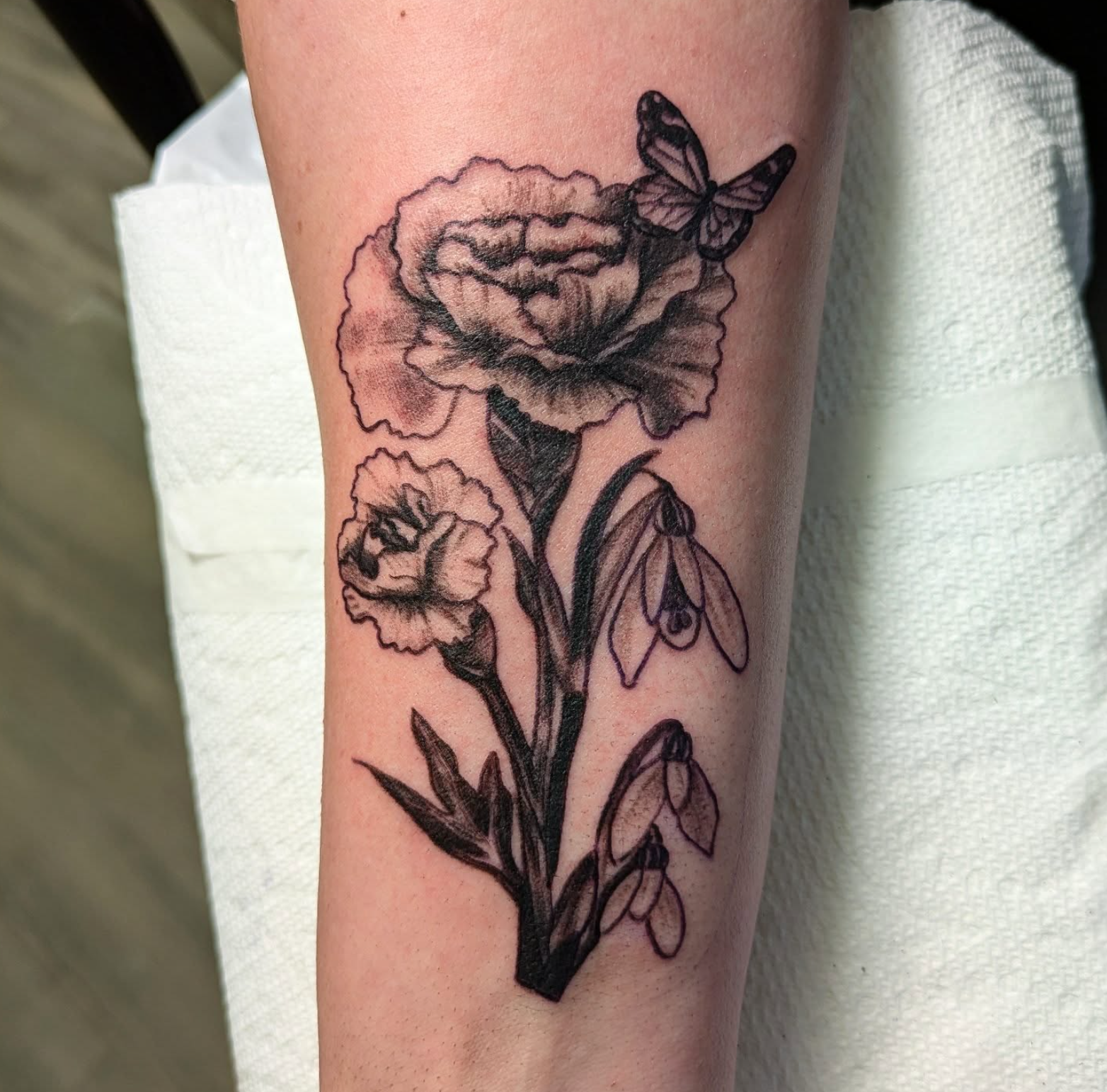 Flowers and Butterfly tattoo by tattoo artist Willow Thomason located in Wolfville, Nova Scotia