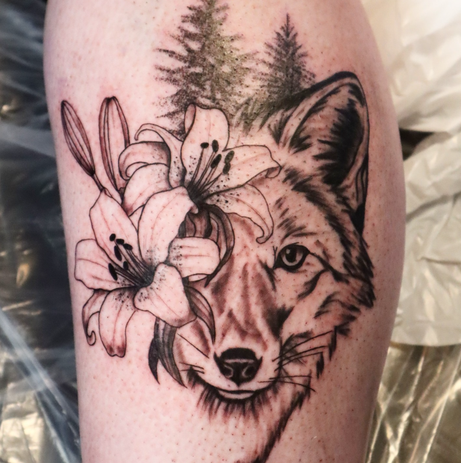 Wolf Trees and Flowers tattoo by tattoo artist Willow Thomason located in Wolfville, Nova Scotia