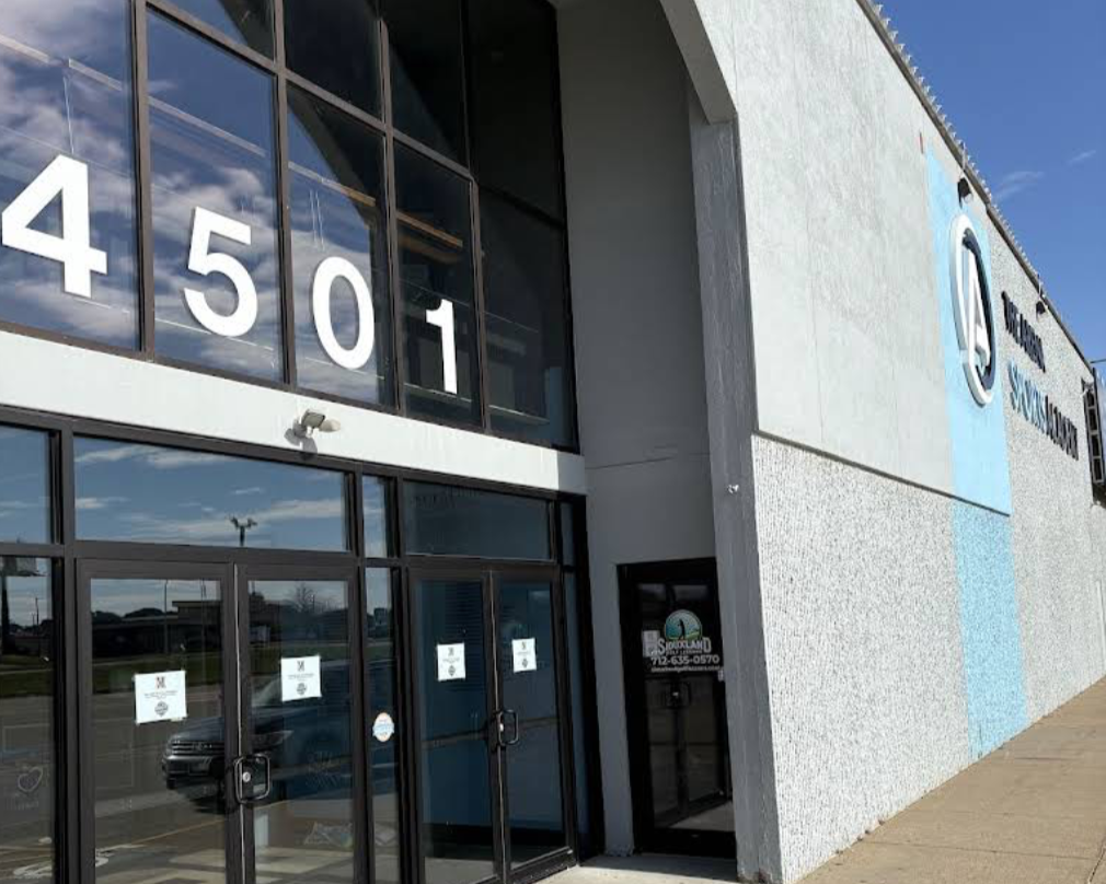 Exterior of a building with large windows displaying the address 4501 and a sign for Oakland Unified School District.