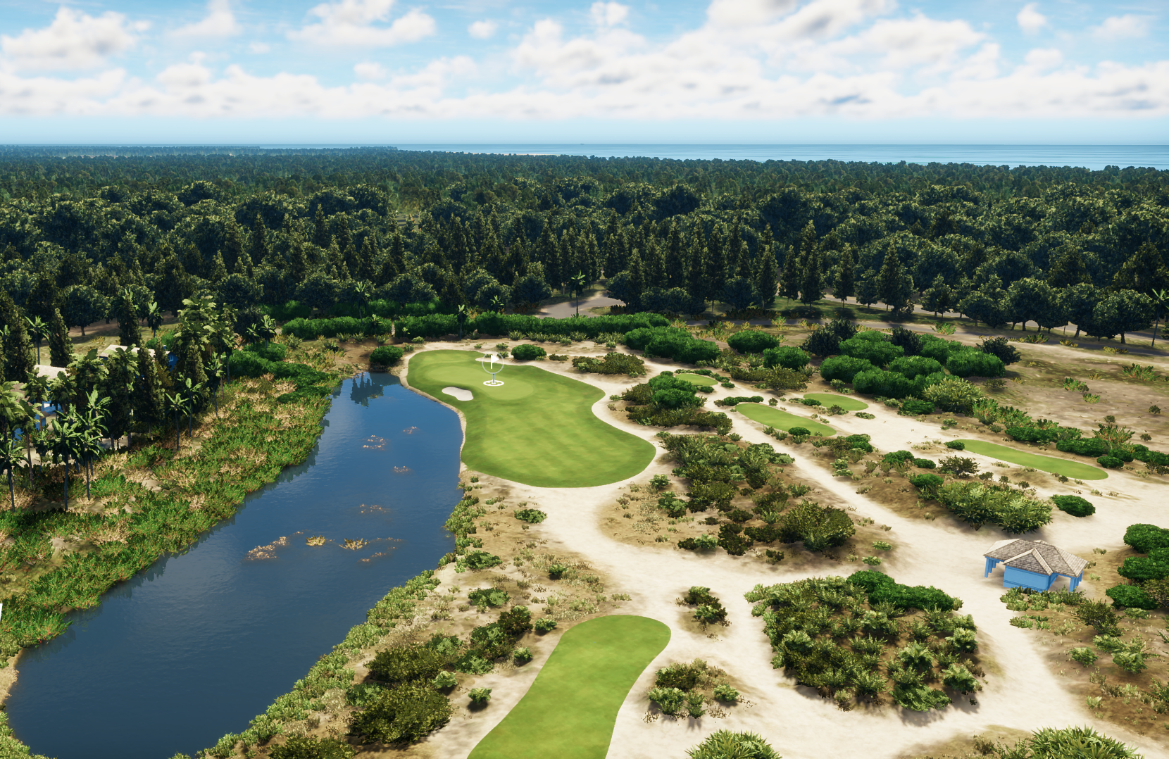 A view of a golf course with a water hazard, surrounded by trees and bushes, features a small building, with a dense forest and ocean in the background under a partly cloudy sky.