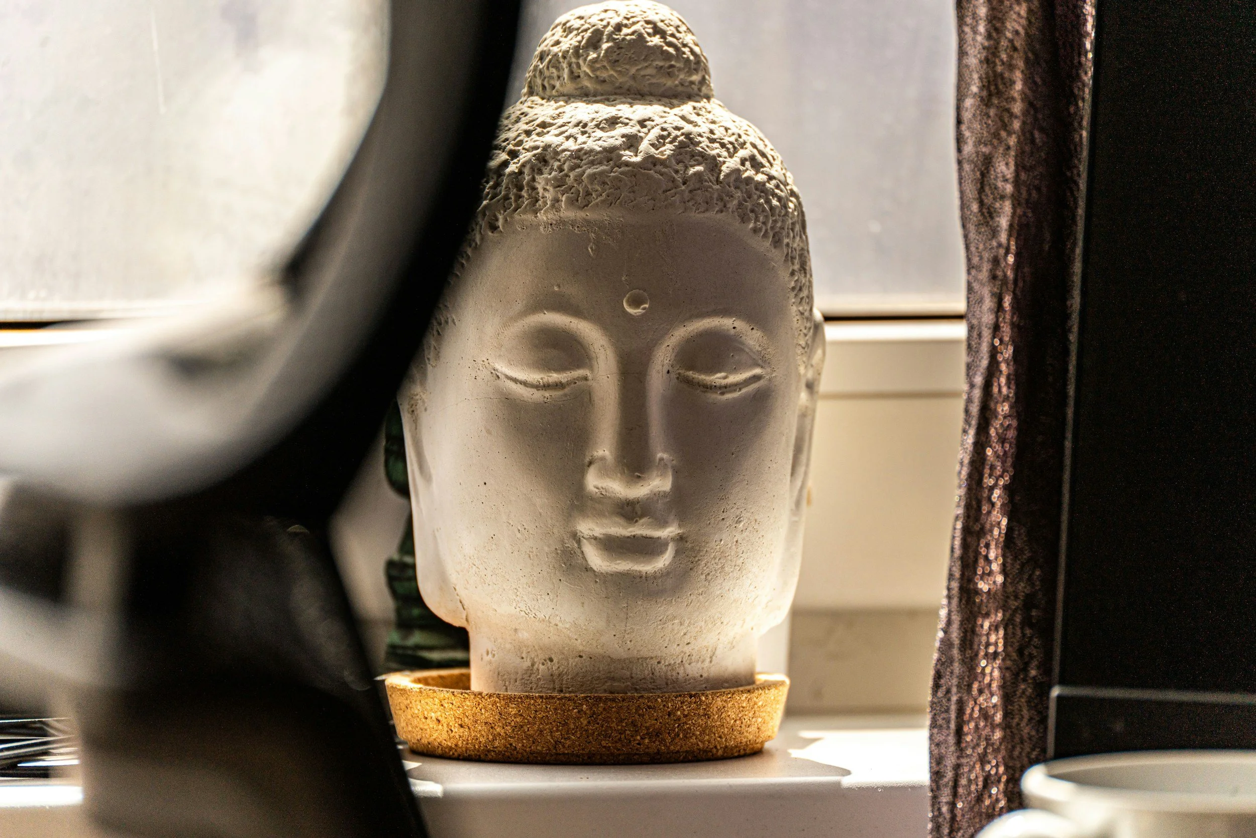 Buddha statue symbolizing mindfulness and traditional healing, reflecting the Ayurvedic and Traditional Chinese Medicine influences behind holistic facial treatments at Coastal Wellness in New Smyrna Beach, FL.