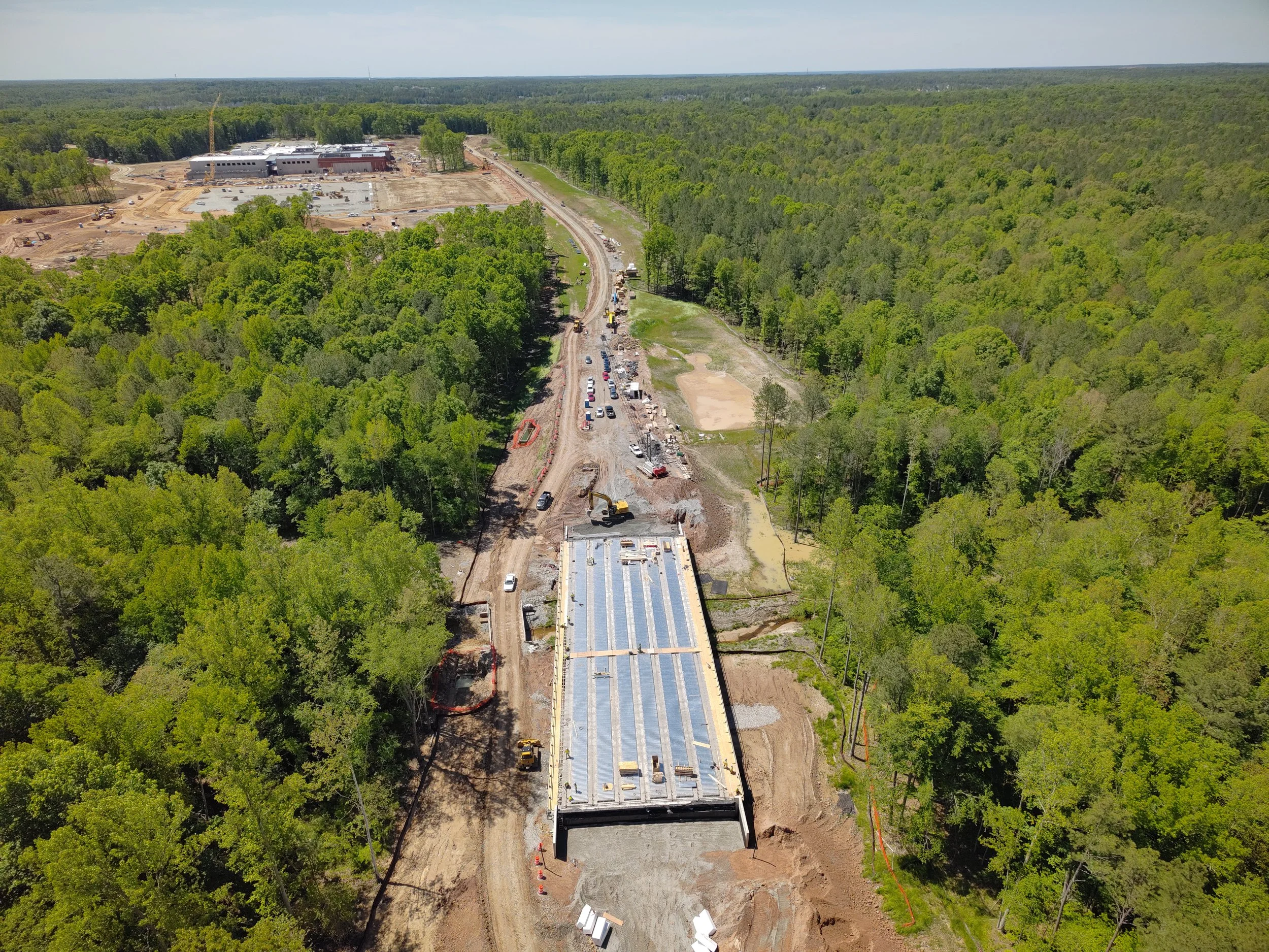 Curb, asphalt, and pavement markings complete to Western Area Elementary school. Bridge girders set with deck pour to follow. 