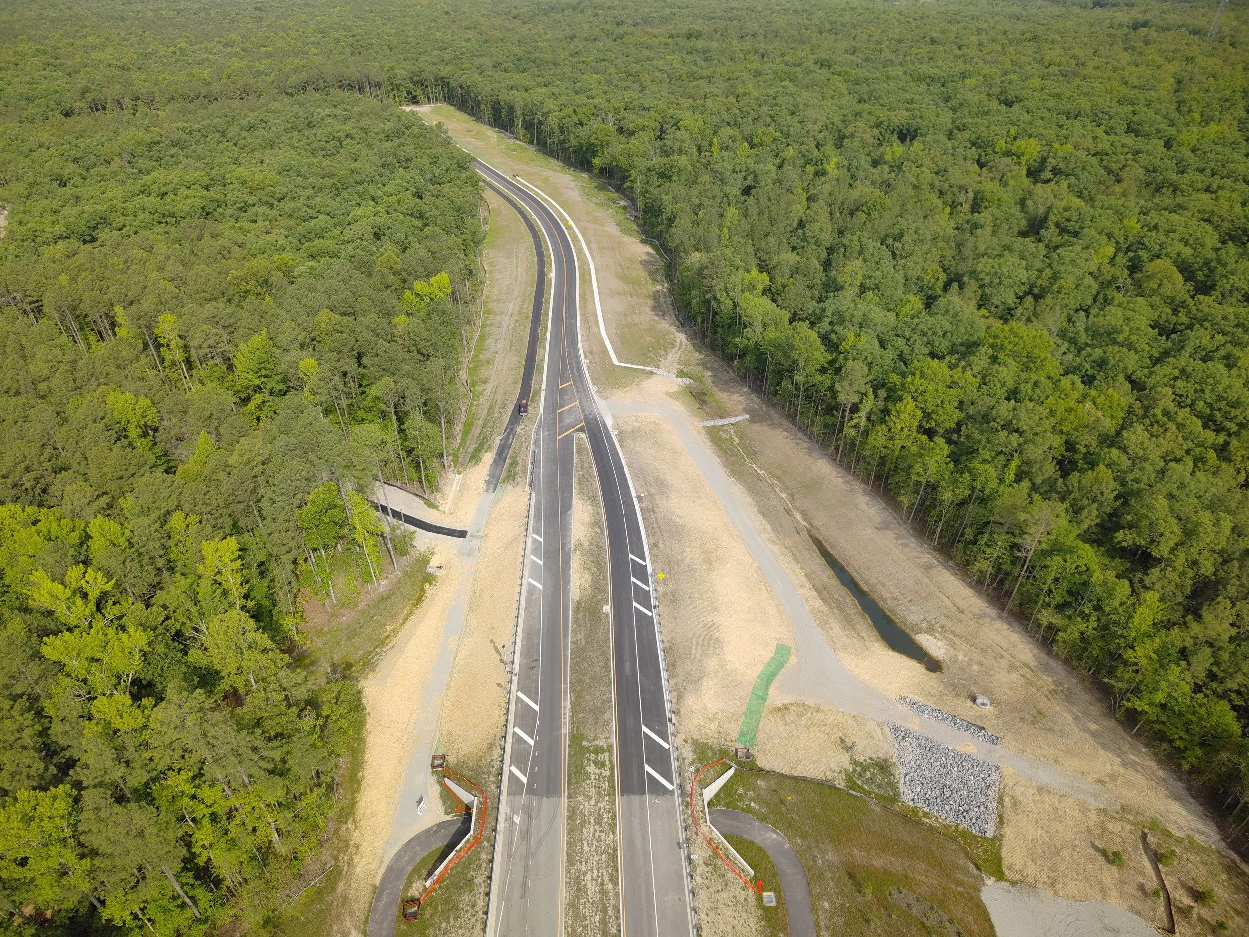 Waterline and roadway work continues. Bridge deck pour completed. Roundabout construction at Duval begins. 