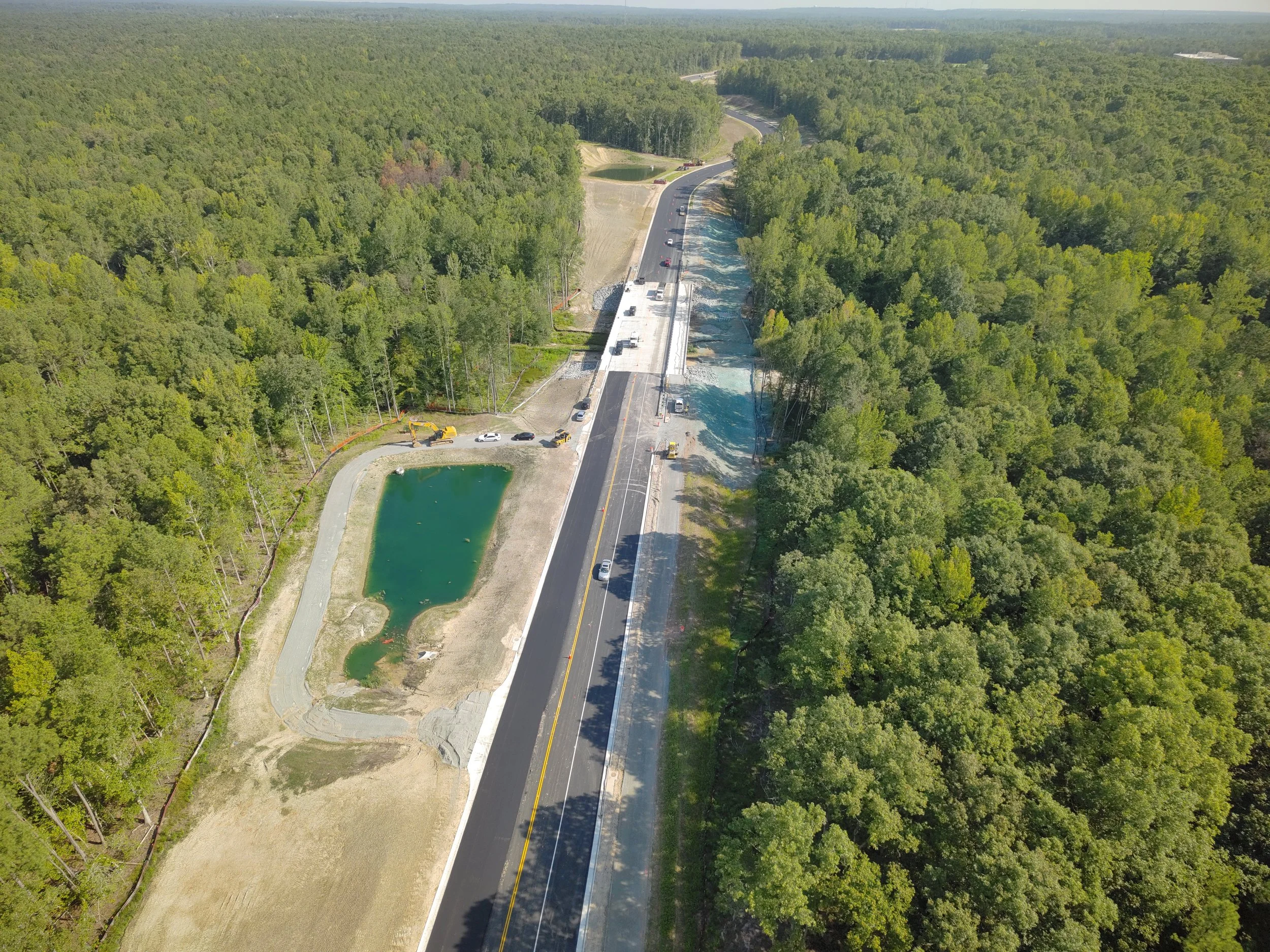 John Thomas Way paving complete and open to two-way traffic. Roundabout construction continues. Duval road reconstruction begins.