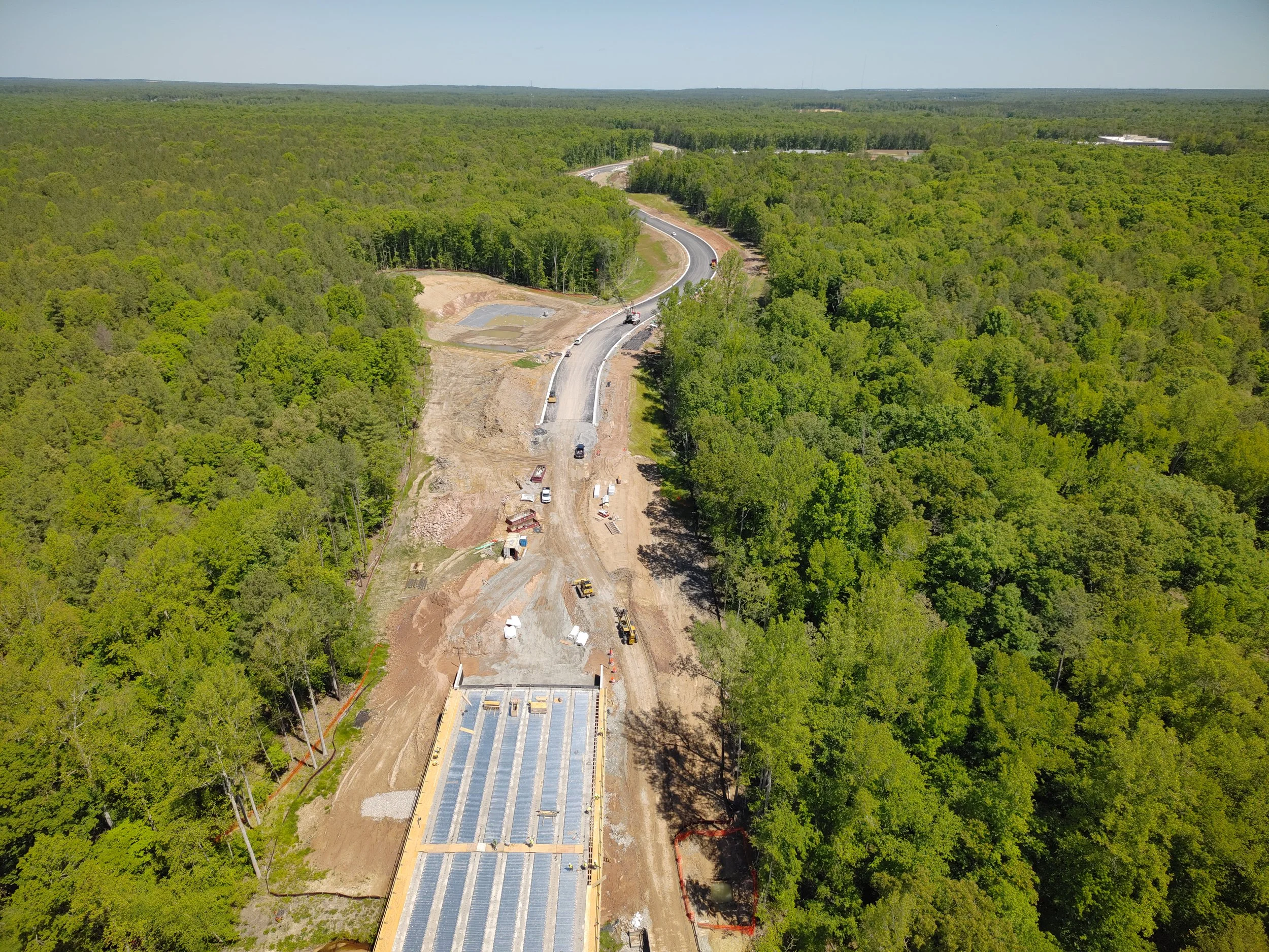 Curb, asphalt, and pavement markings complete to Western Area Elementary school. Bridge girders set with deck pour to follow. 