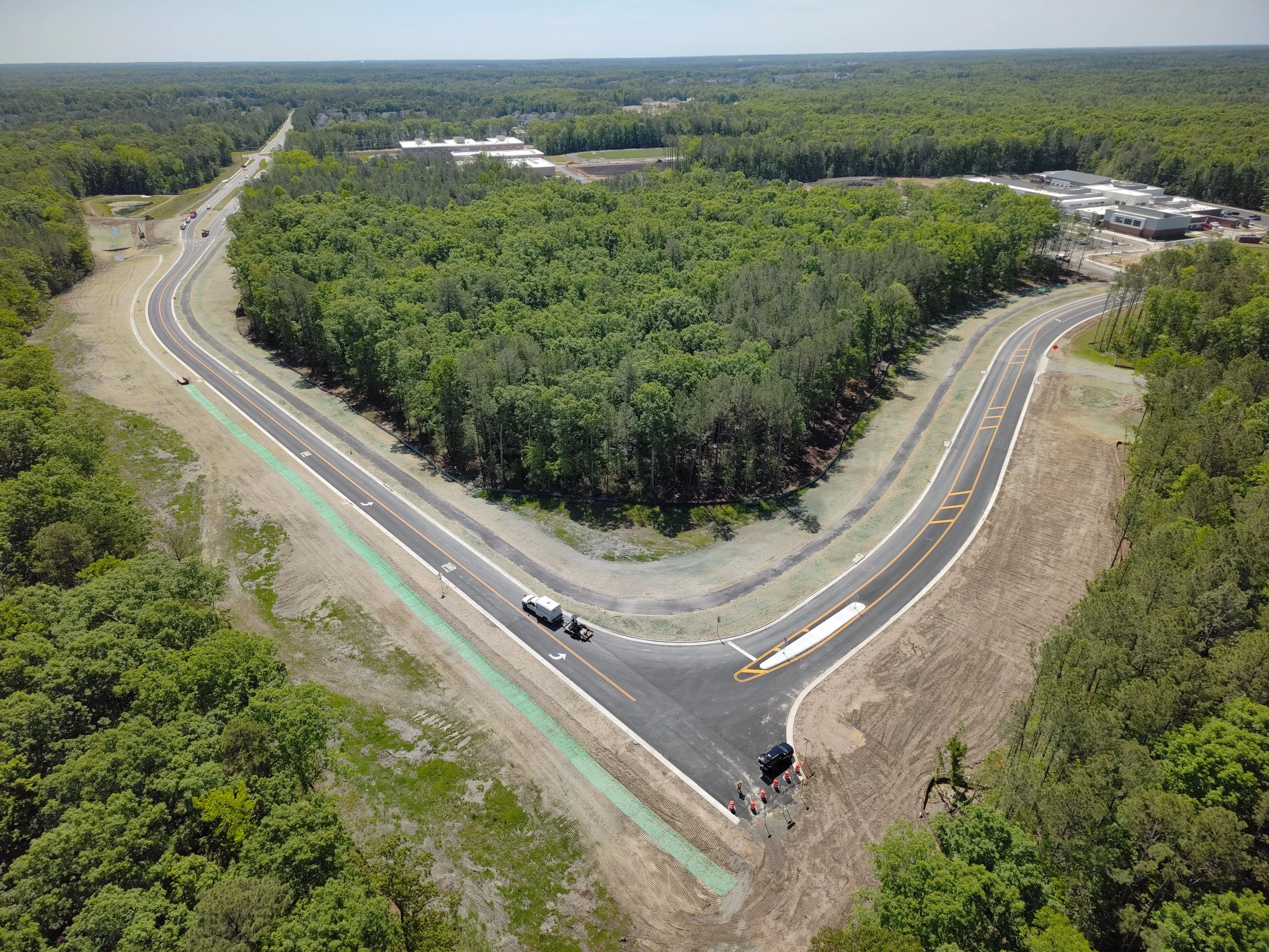 Curb, asphalt, and pavement markings complete to Western Area Elementary school. Bridge girders set with deck pour to follow. 