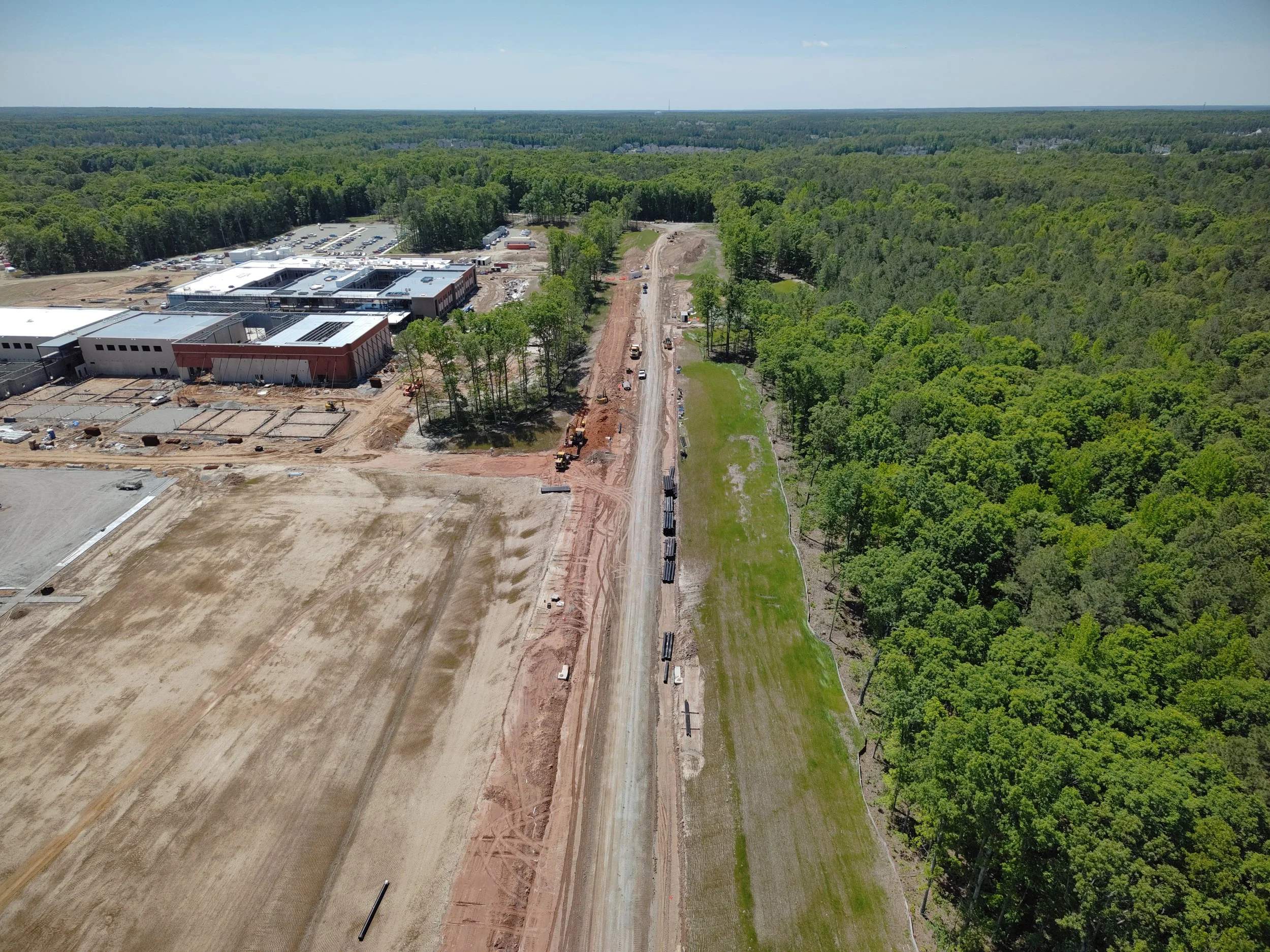 Curb, asphalt, and pavement markings complete to Western Area Elementary school. Bridge girders set with deck pour to follow. 