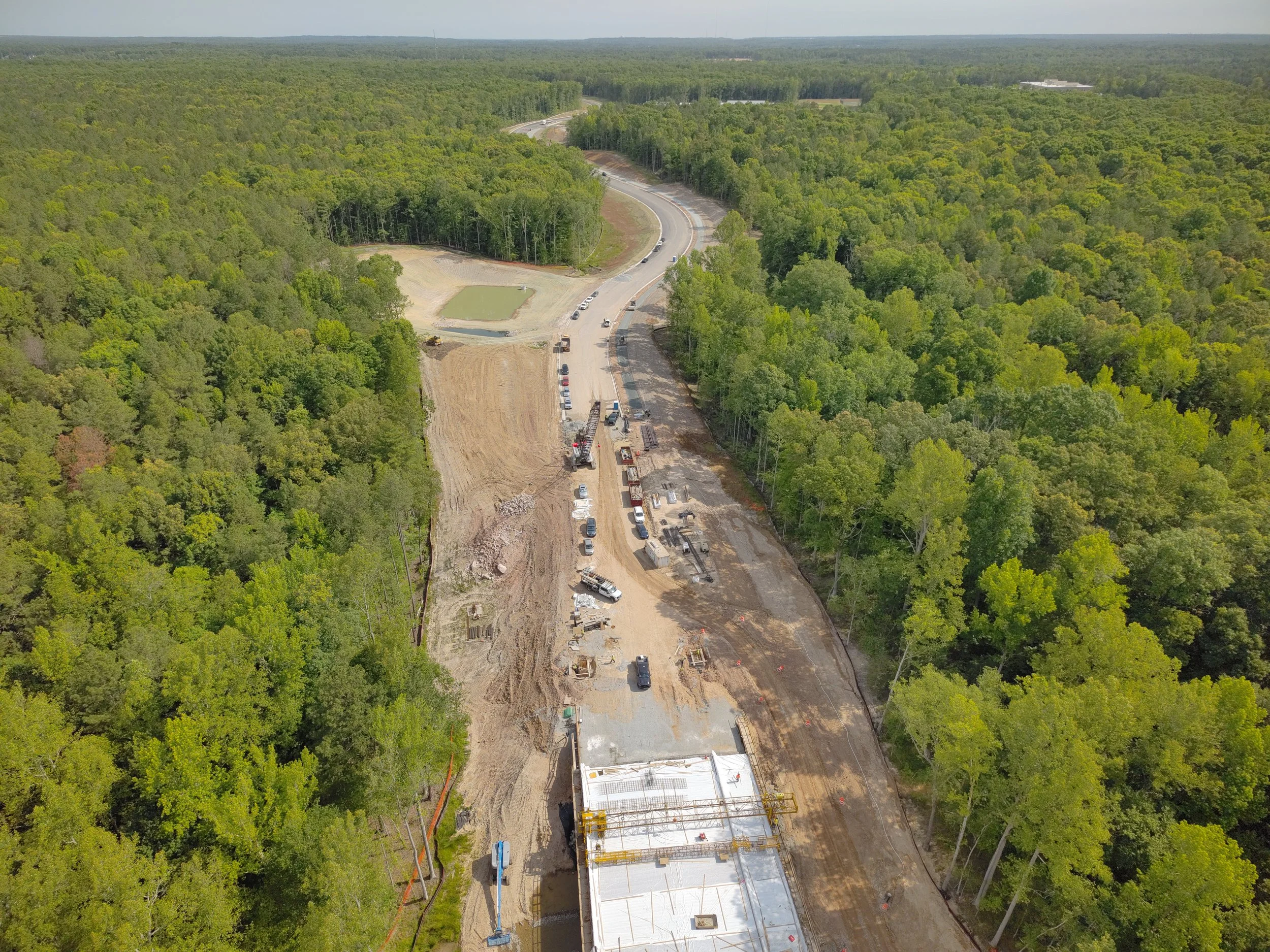 Waterline and roadway work continues. Bridge deck pour completed. Roundabout construction at Duval begins. 