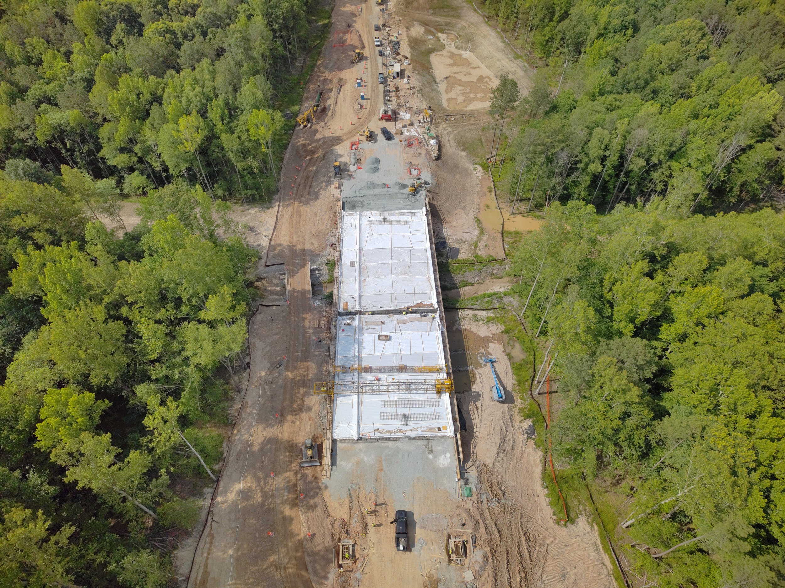 Waterline and roadway work continues. Bridge deck pour completed. Roundabout construction at Duval begins. 