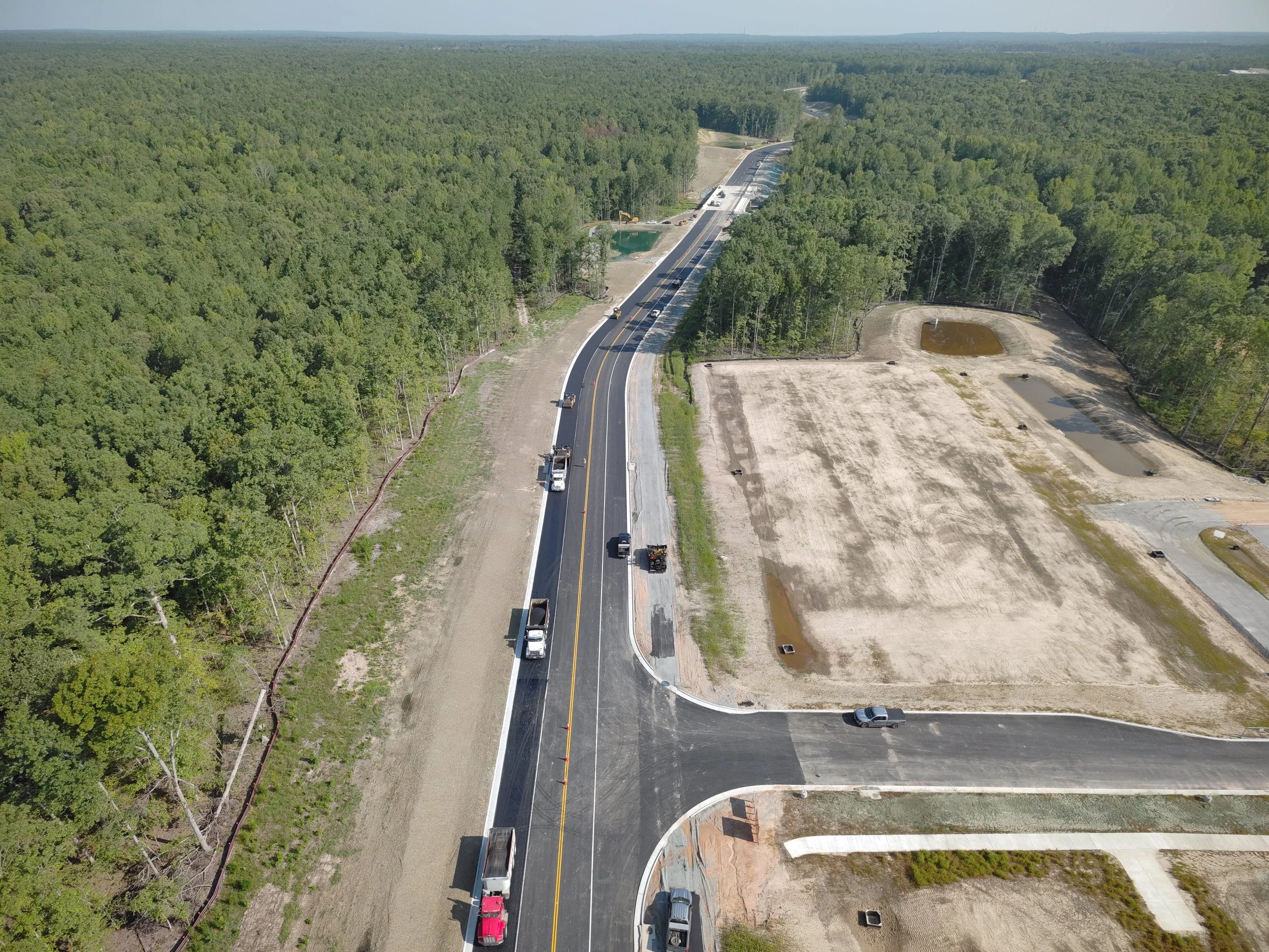 John Thomas Way paving complete and open to two-way traffic. Roundabout construction continues. Duval road reconstruction begins.