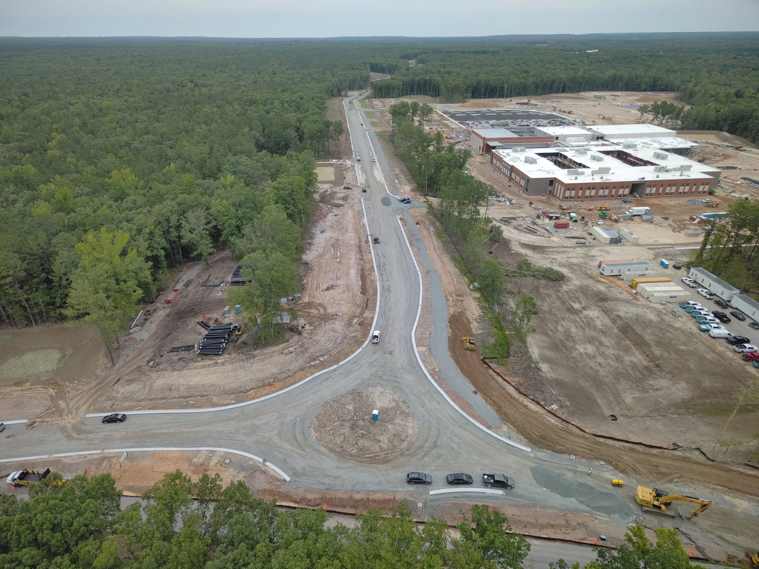 Roadway work continues with curb/underdrain installation and paving to follow. Work on the bridge reaches final stages with sidewalk and railing installation.