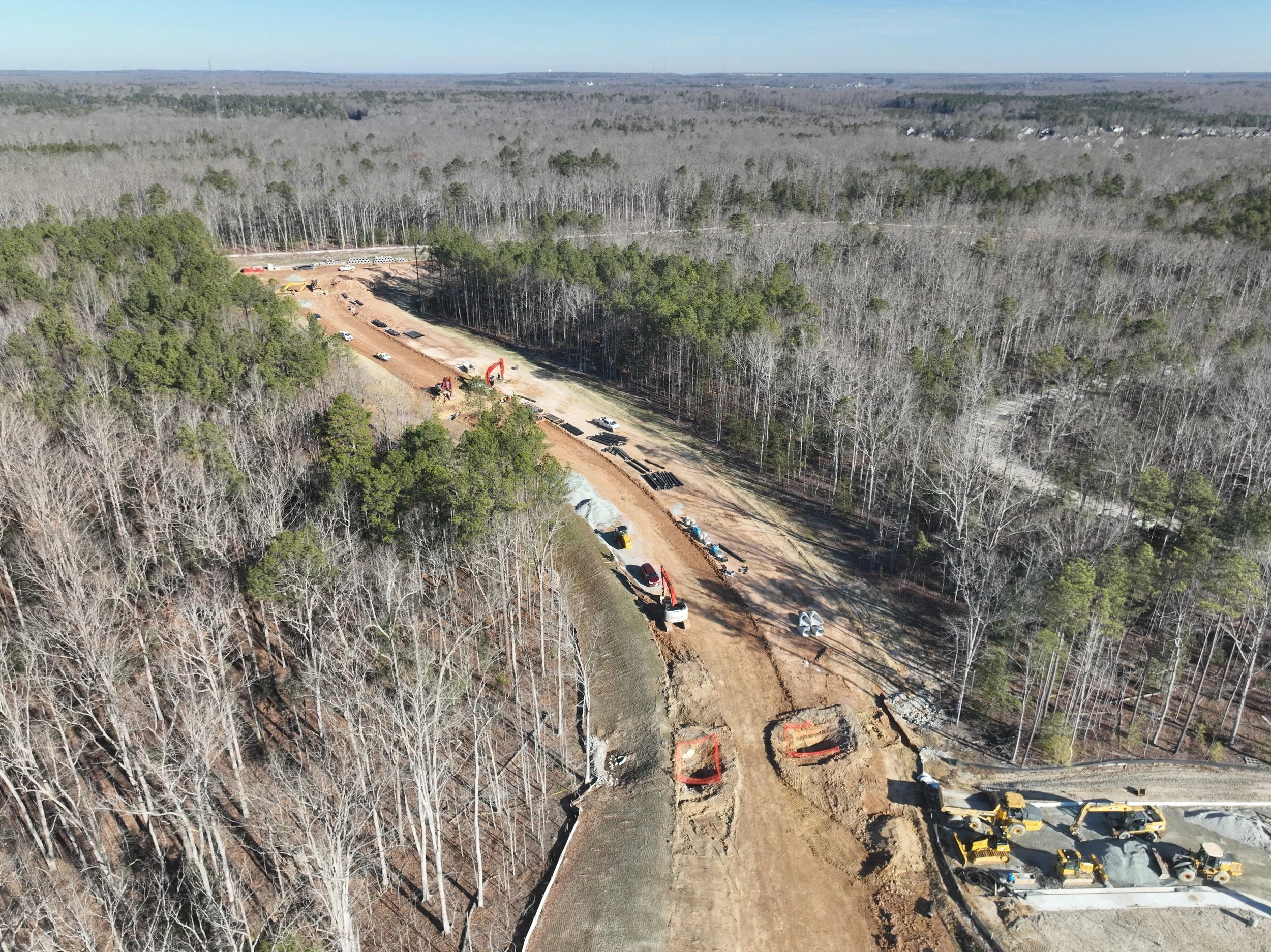 Roadway, waterline, and bridge work continues.