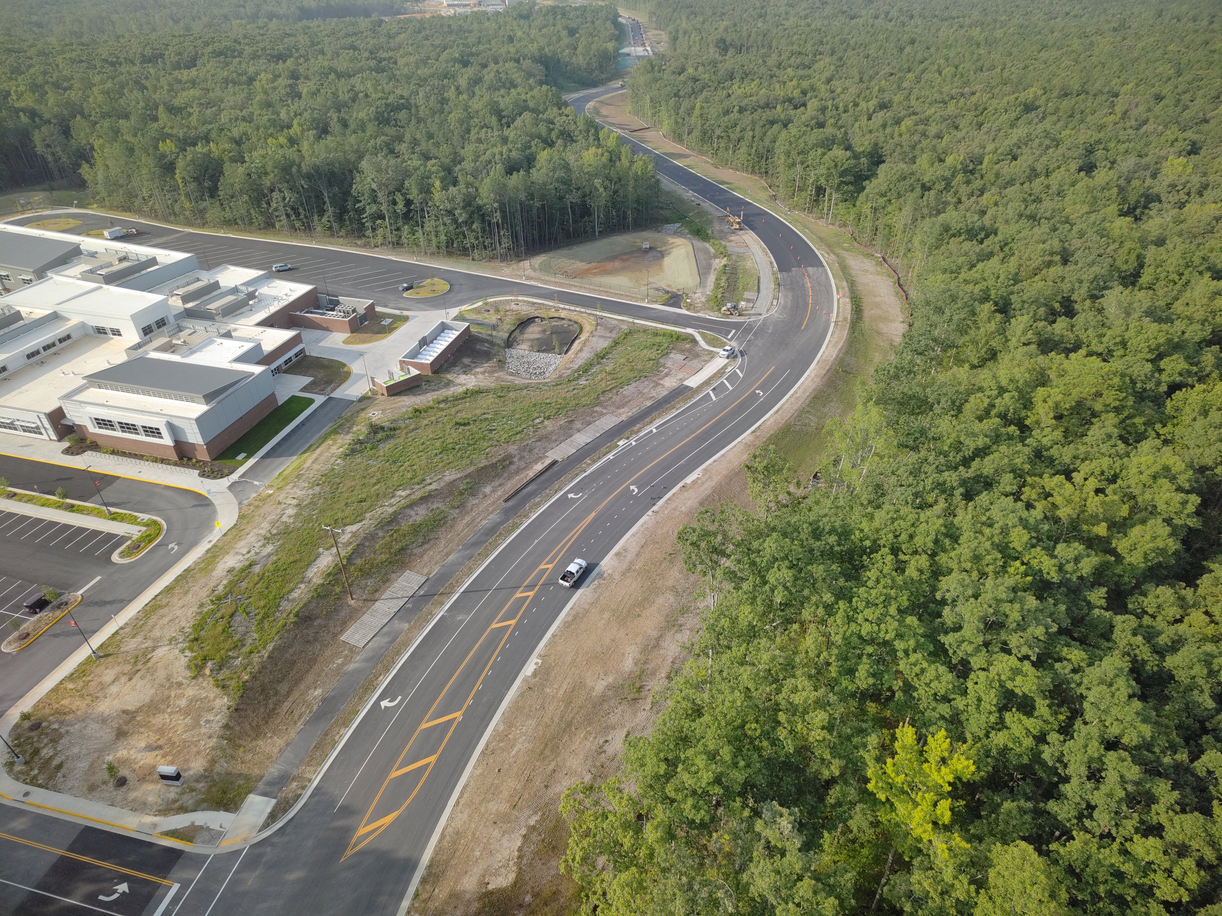 John Thomas Way paving complete and open to two-way traffic. Roundabout construction continues. Duval road reconstruction begins.