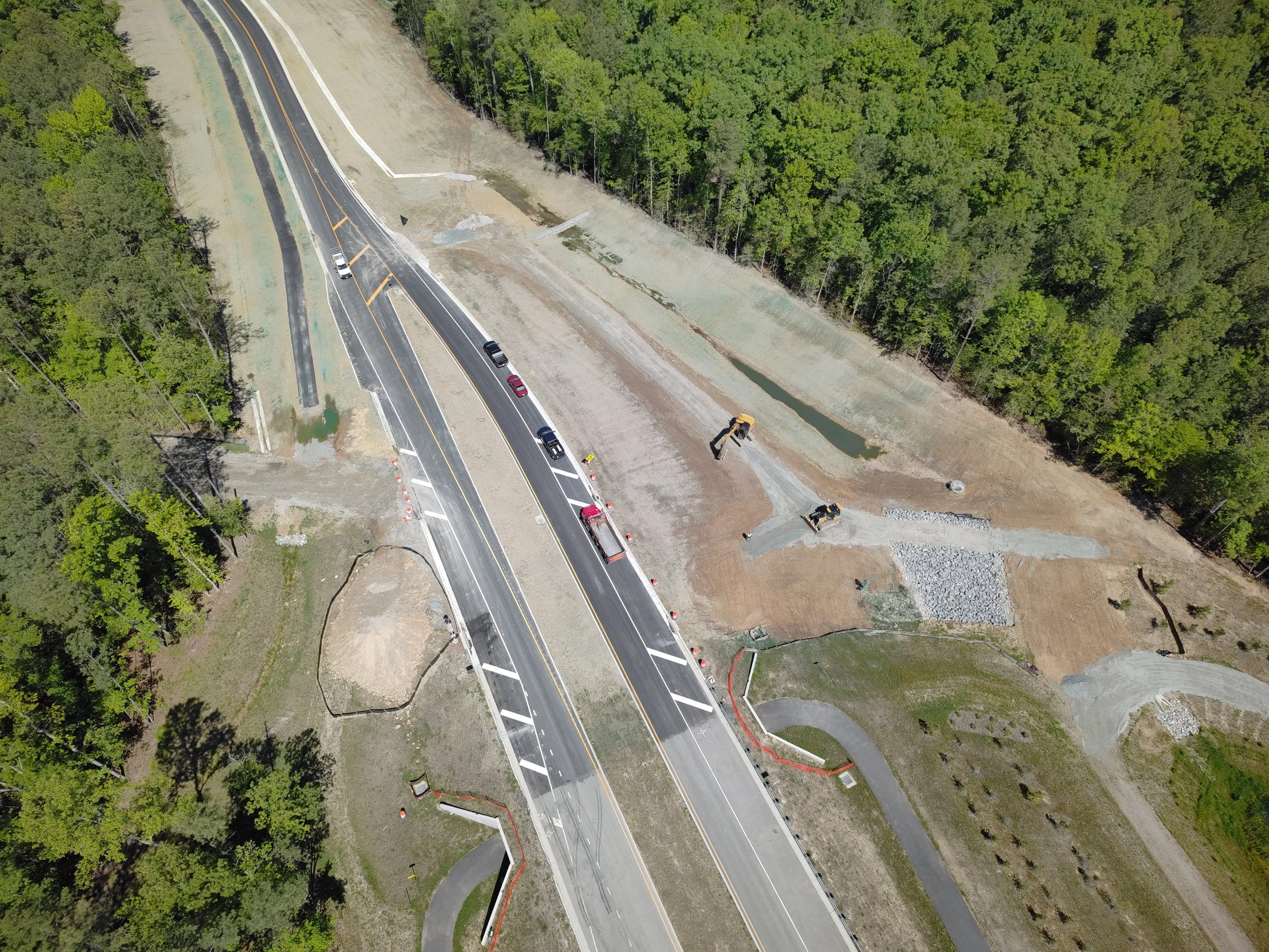 Curb, asphalt, and pavement markings complete to Western Area Elementary school. Bridge girders set with deck pour to follow. 