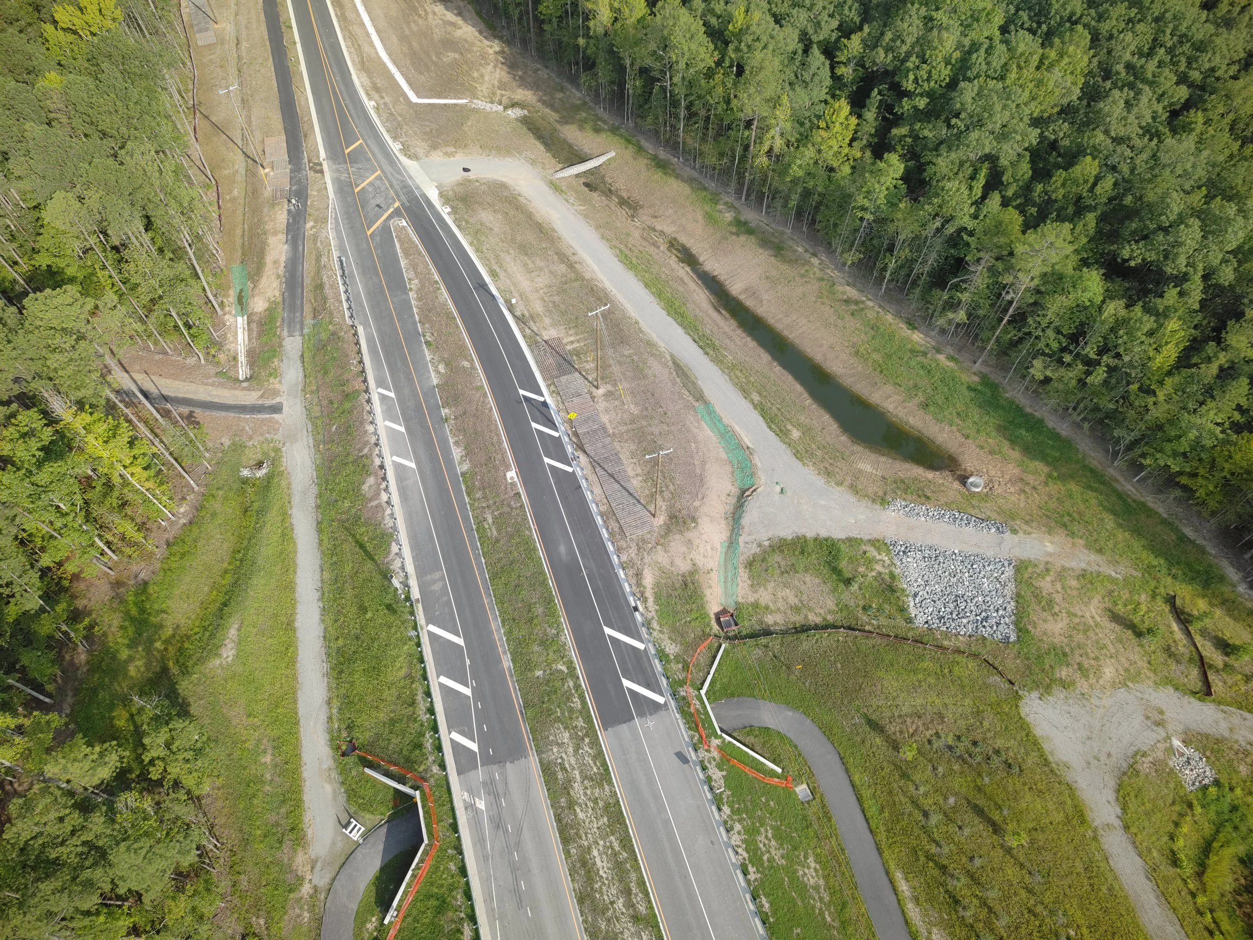 John Thomas Way paving complete and open to two-way traffic. Roundabout construction continues. Duval road reconstruction begins.