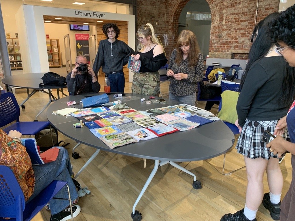 Workshop lead by Ruby to finish attaching the Quilt