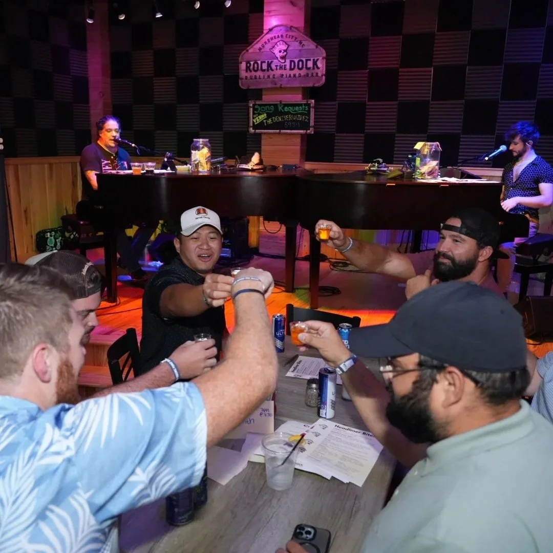 Live dueling piano show at Rock the Dock in Morehead City NC with guests raising drinks and enjoying the music
