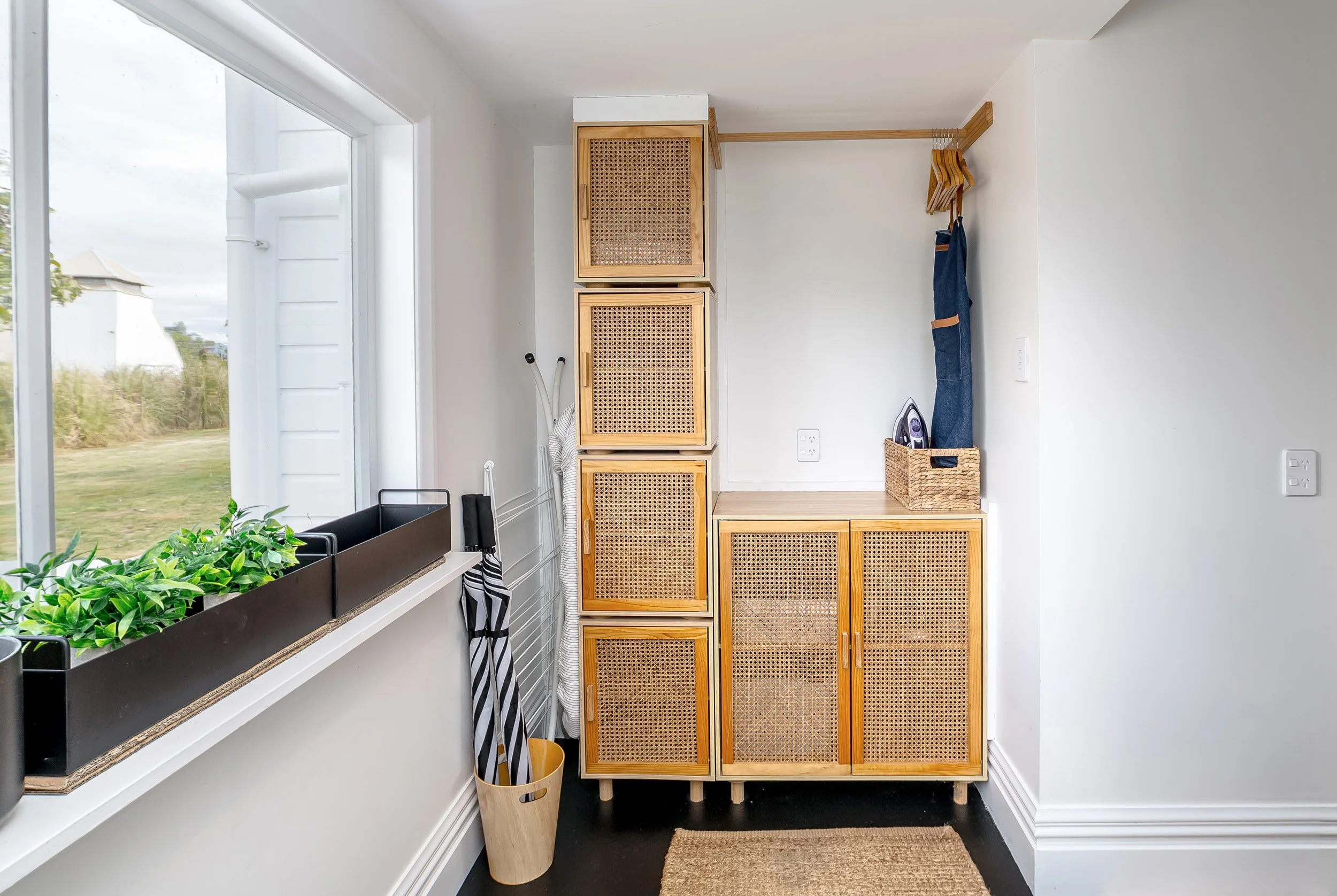 A cloakroom with white walls, wicker cabinetry and an area for hanging clothes. Great for weekend stays, small weddings and post wedding events, group gatherings, celebrations and holidays.