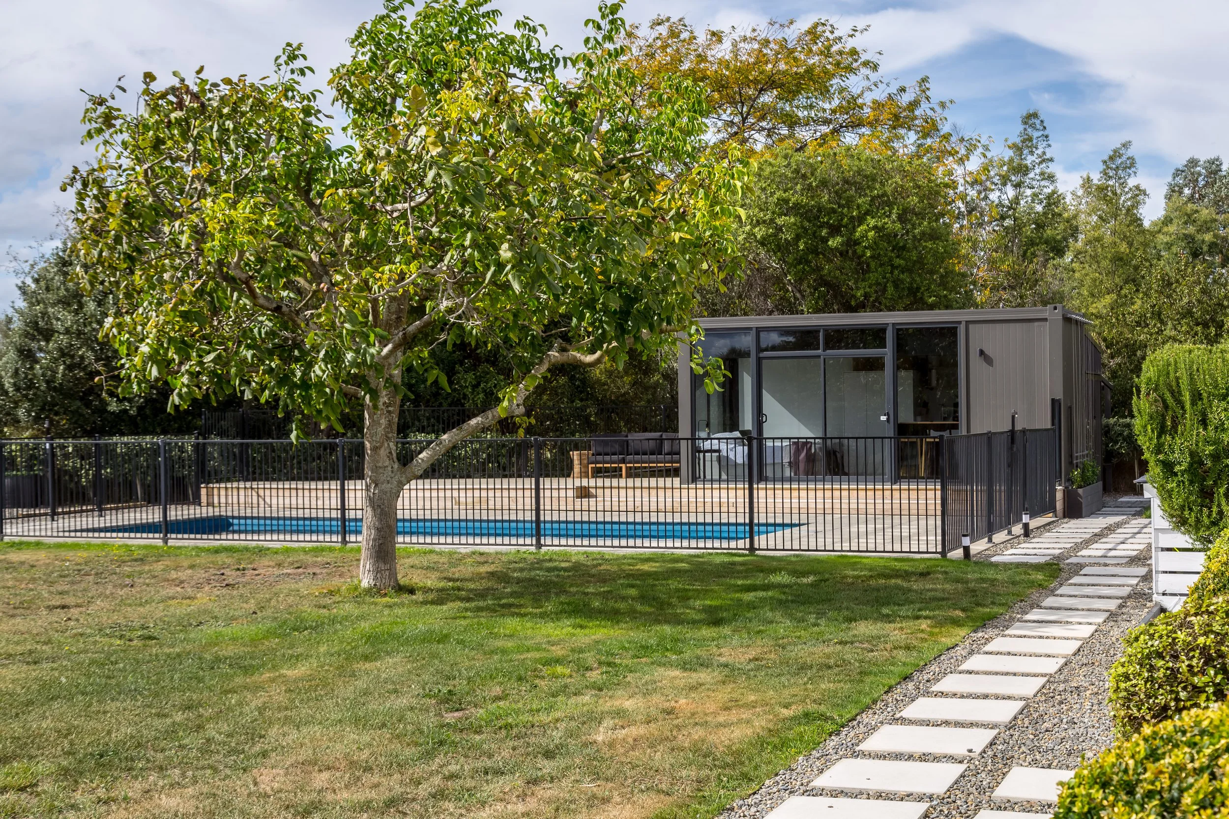 A well kept lawn with a large green lawn, swimming pool and modern pool house. Great for weekend stays, small weddings and post wedding events, group gatherings, celebrations and holidays.