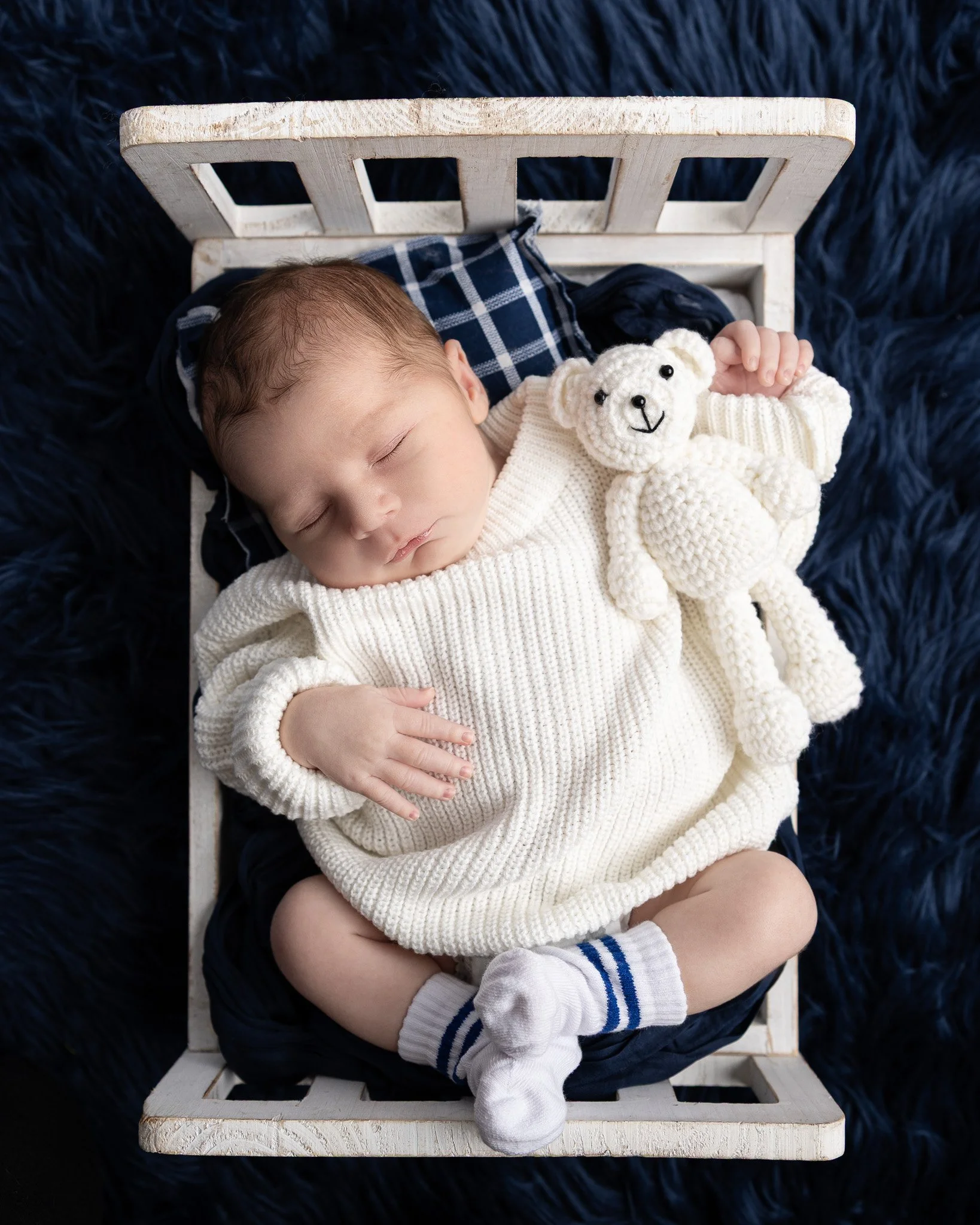 Peaceful newborn sleeping during Davison studio session.