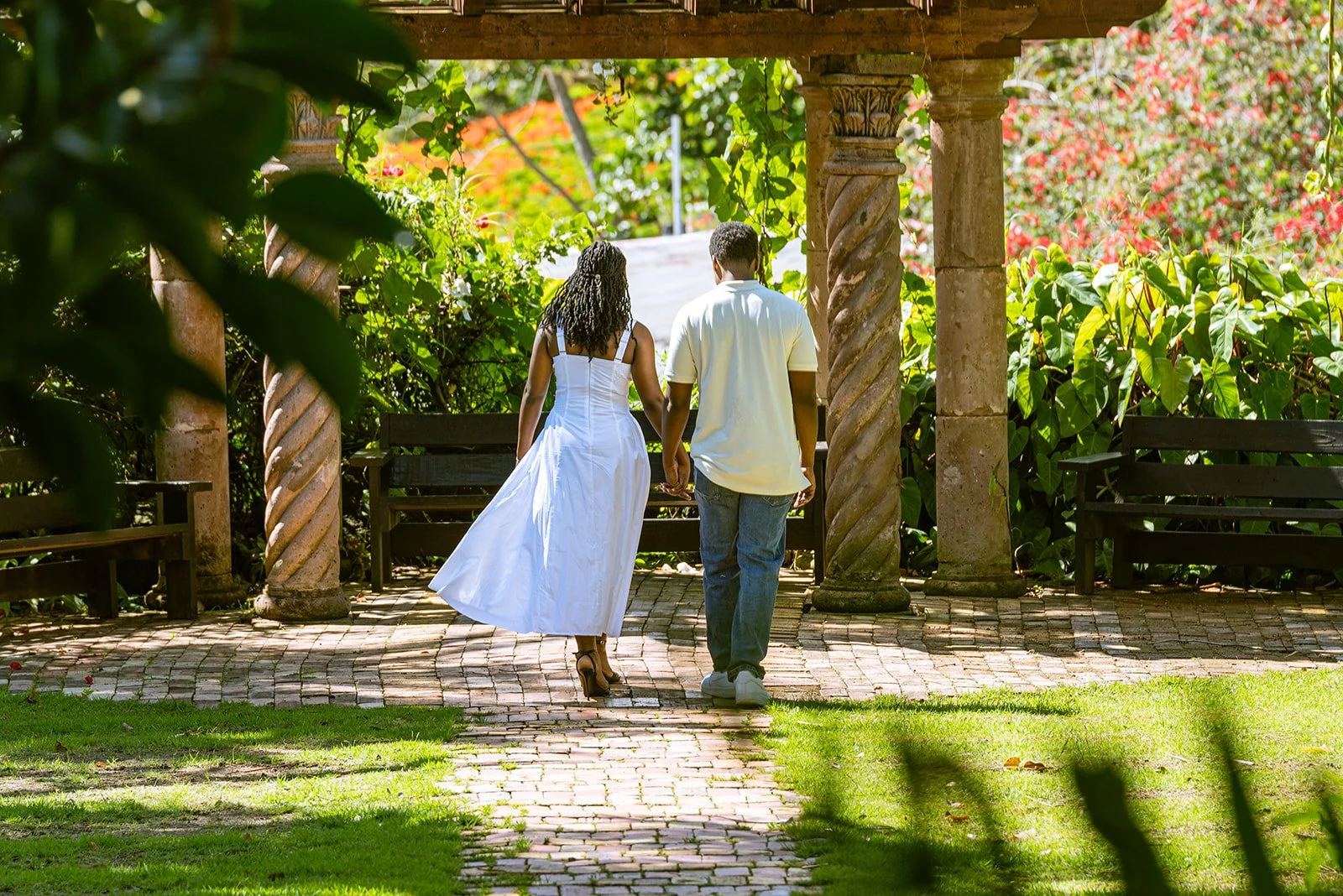 Matai and Toni-Ann walking through the gardens at Hacienda Siesta Alegre before their surprise proposal.