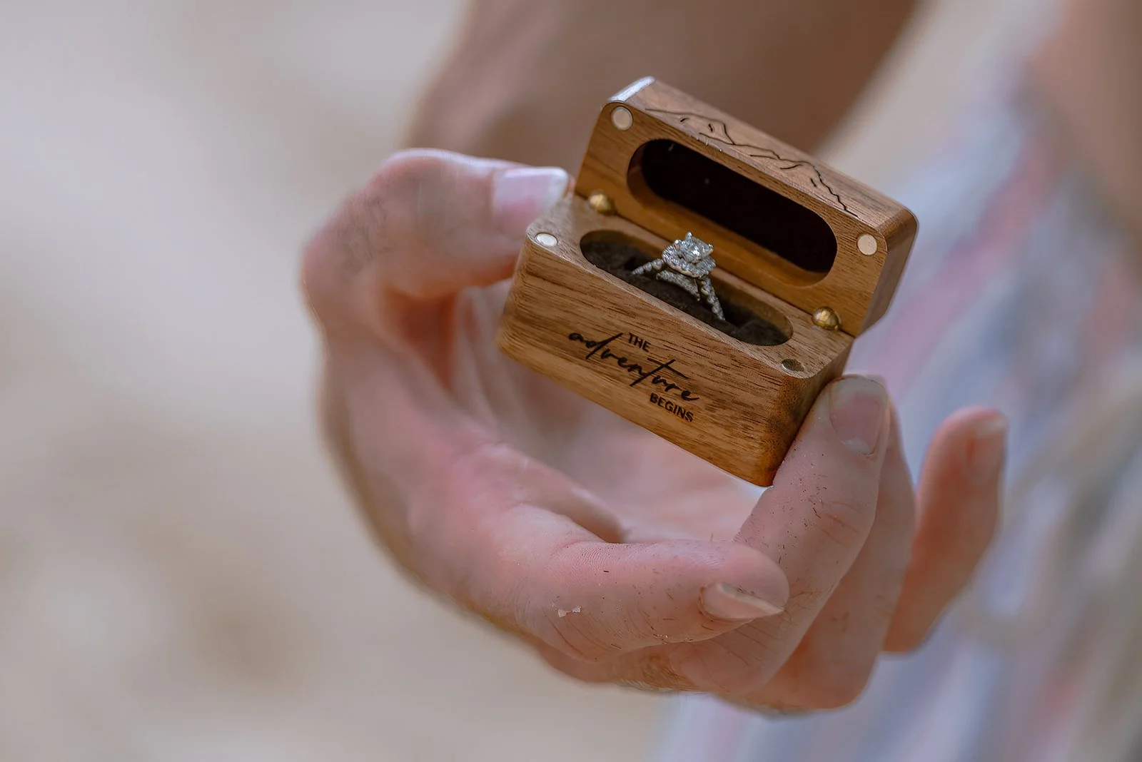 Engagement ring inside a wooden ring box after a proposal