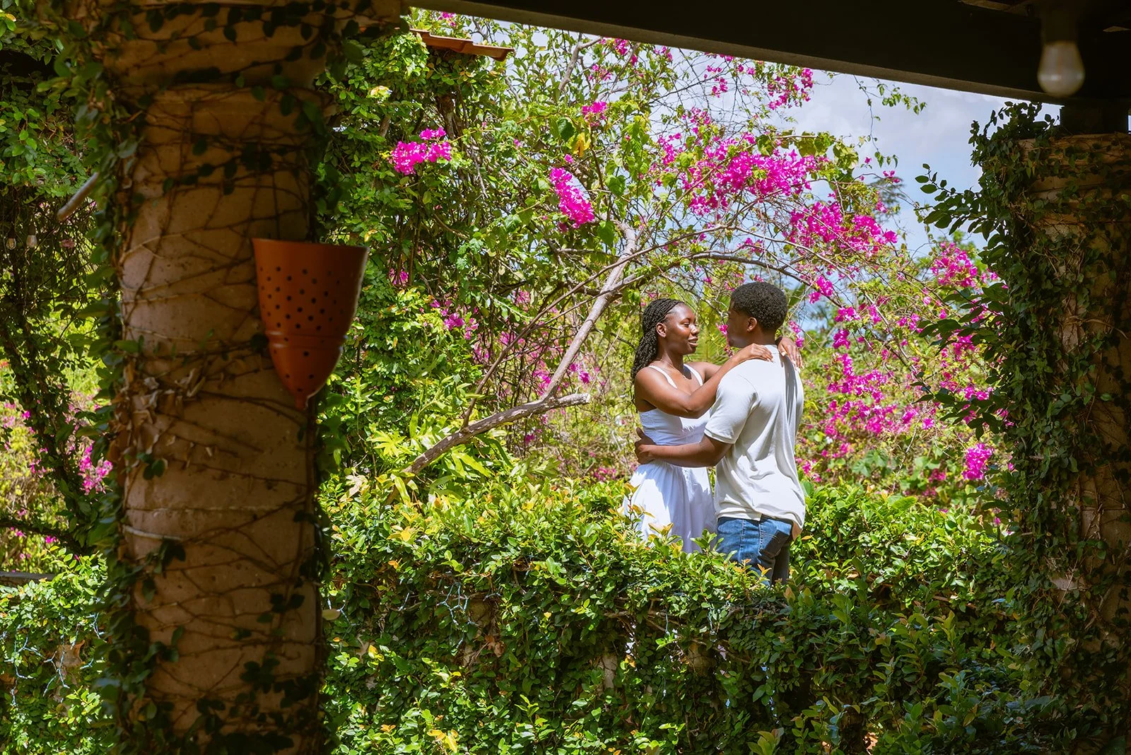Newly engaged couple surrounded by tropical gardens at Hacienda Siesta Alegre