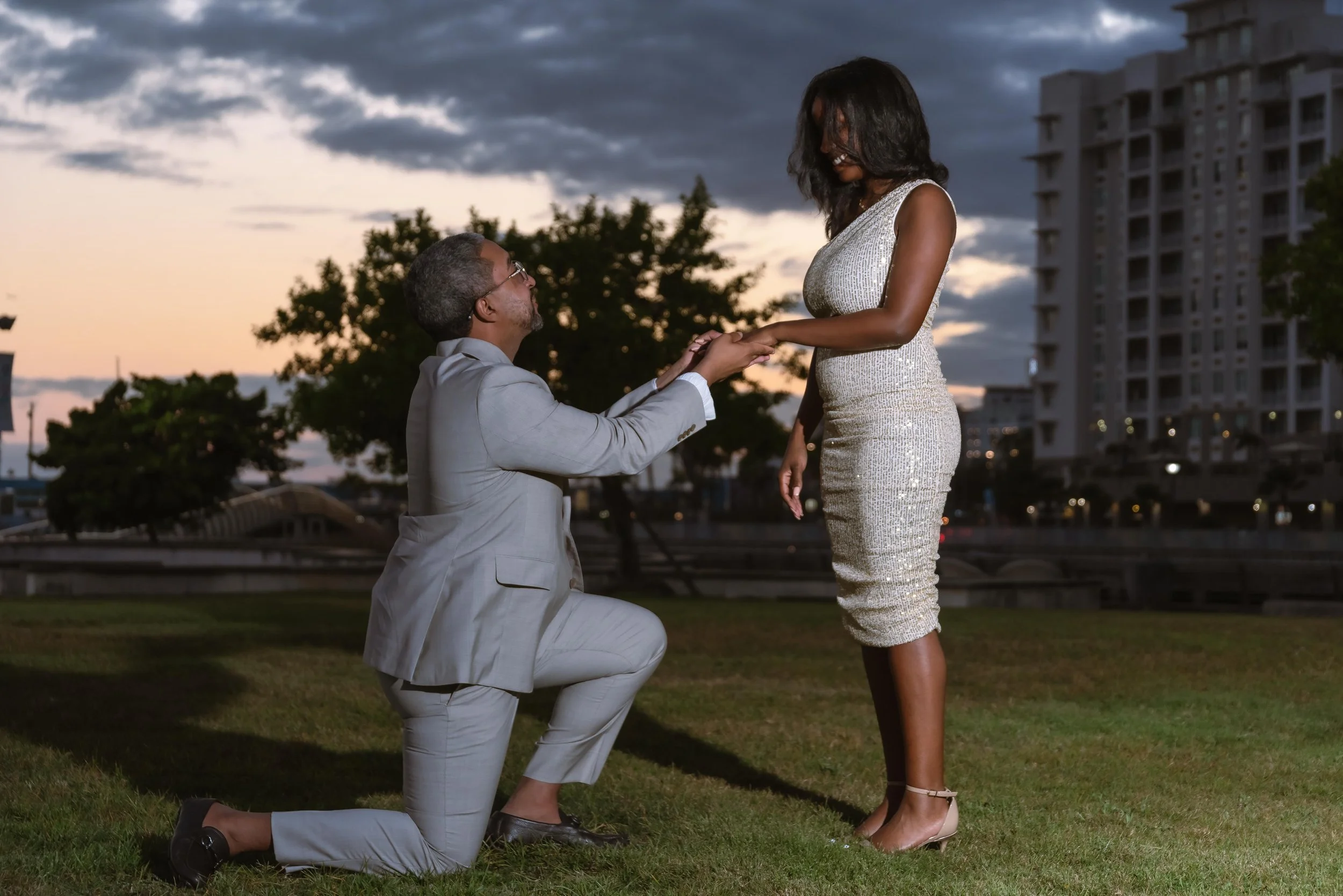 Man proposing to his partner at sunset during a surprise proposal in San Juan, Puerto Rico.