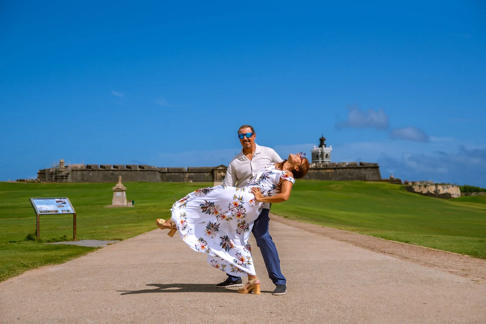 A couple striking a pose in front of El Morro, Old San Juan