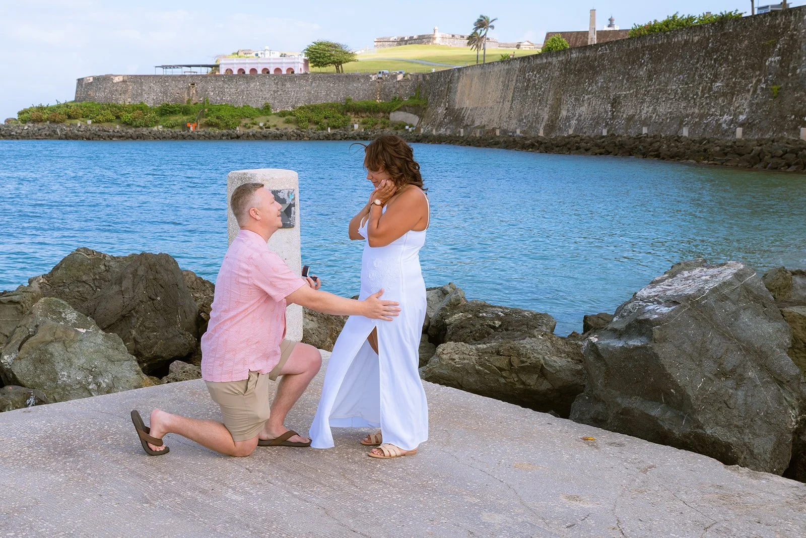 A man kneels in front of his fiancee in Old San Juan, Puerto Rico