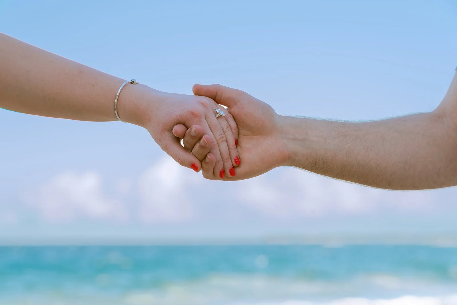 Newly engaged couple holding hands by the ocean in Puerto Rico