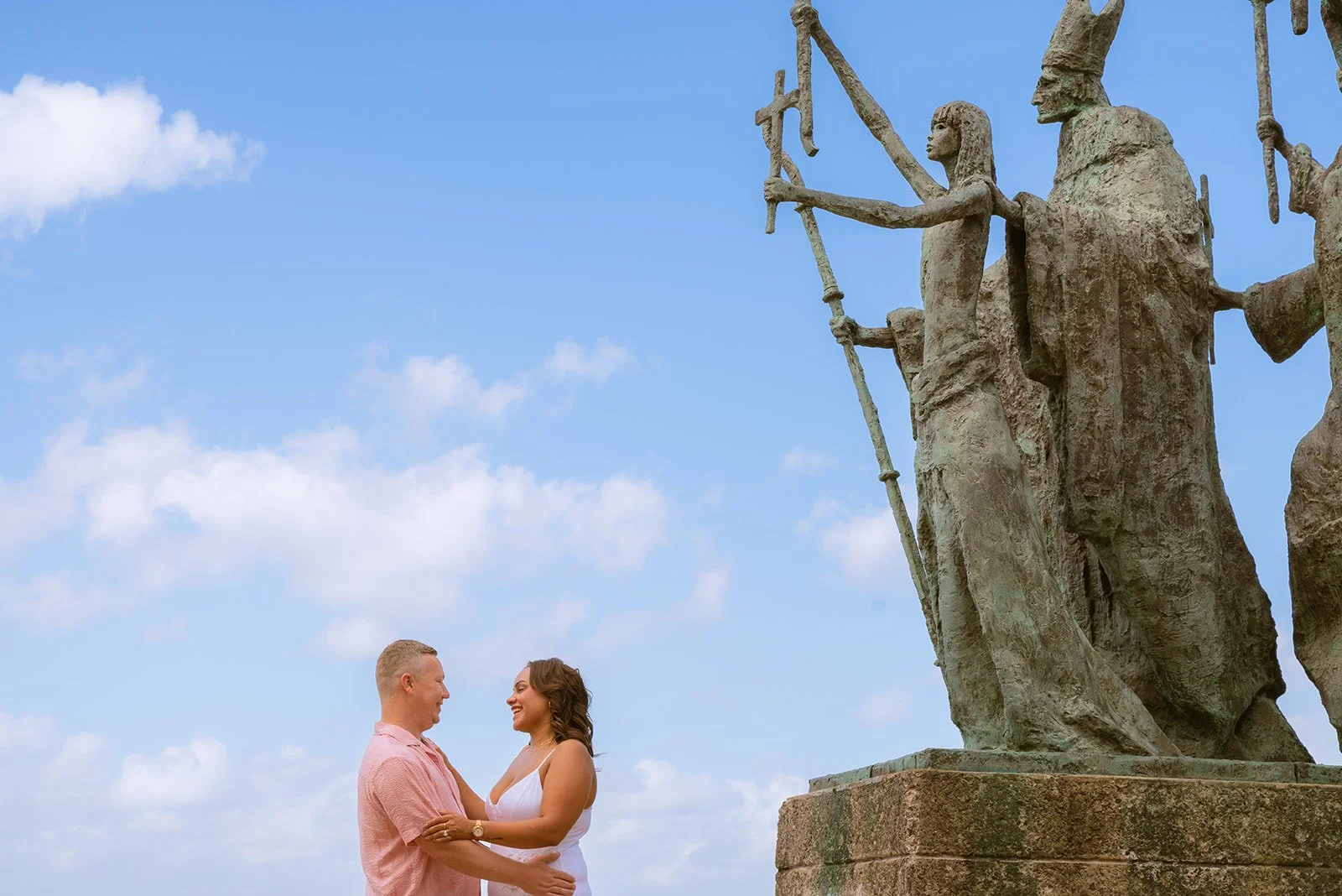 A couple smiling and hugging in front of La Rogativa, Old San Juan