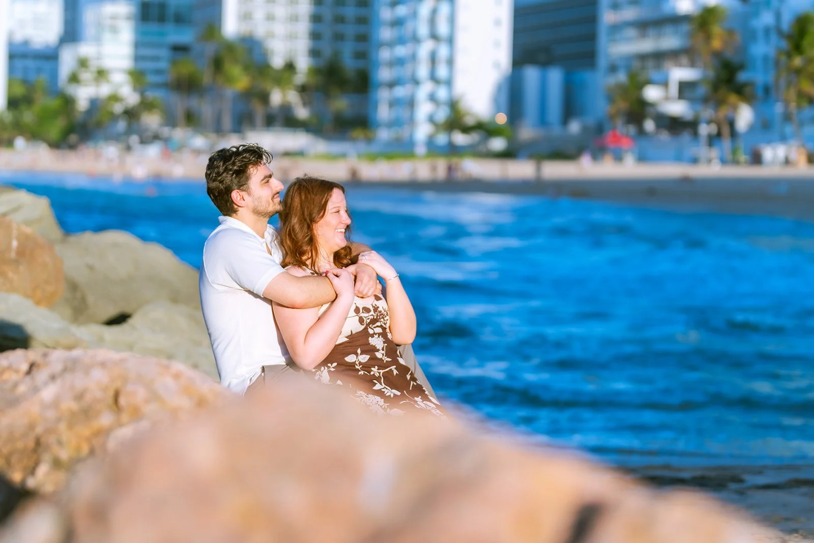 Newly engaged couple celebrating by the ocean in Condado, San Juan