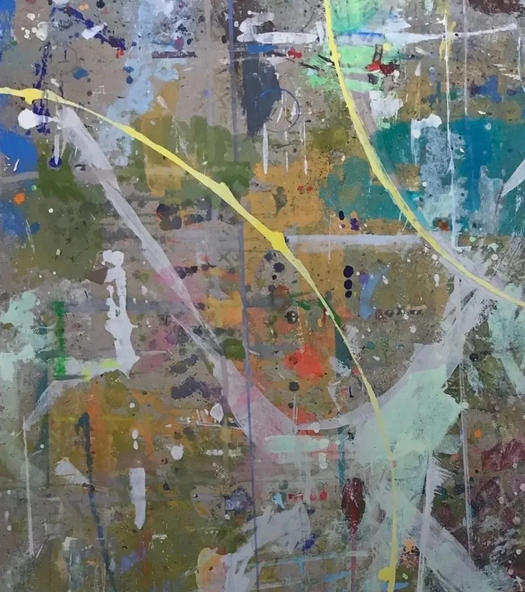 Abstract splatter painting with various colors including yellow, white, blue, green, red, and brown on a textured surface.