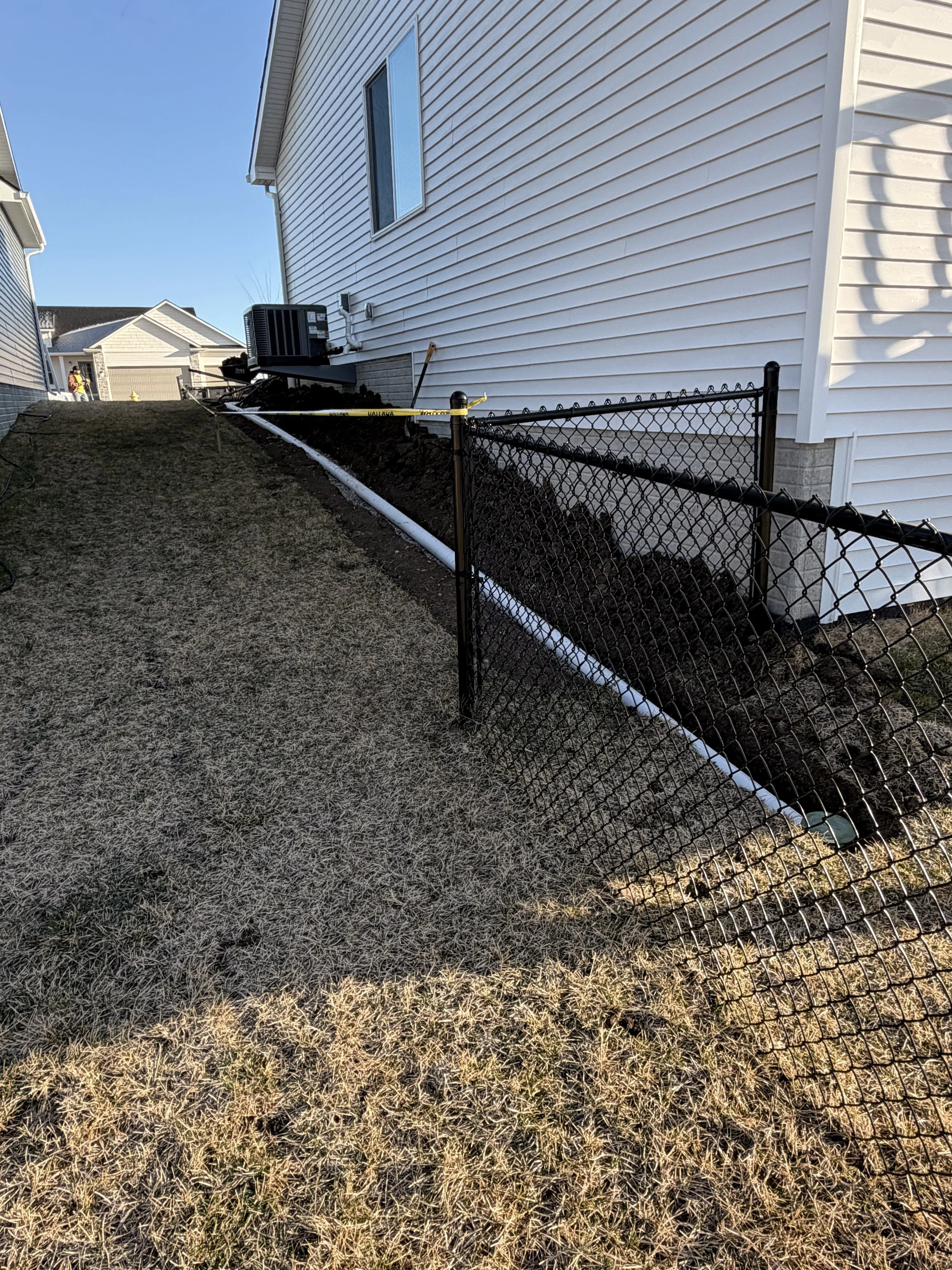 Underground downspout extension and drainage trenching to keep water away from the foundation and flatwork.