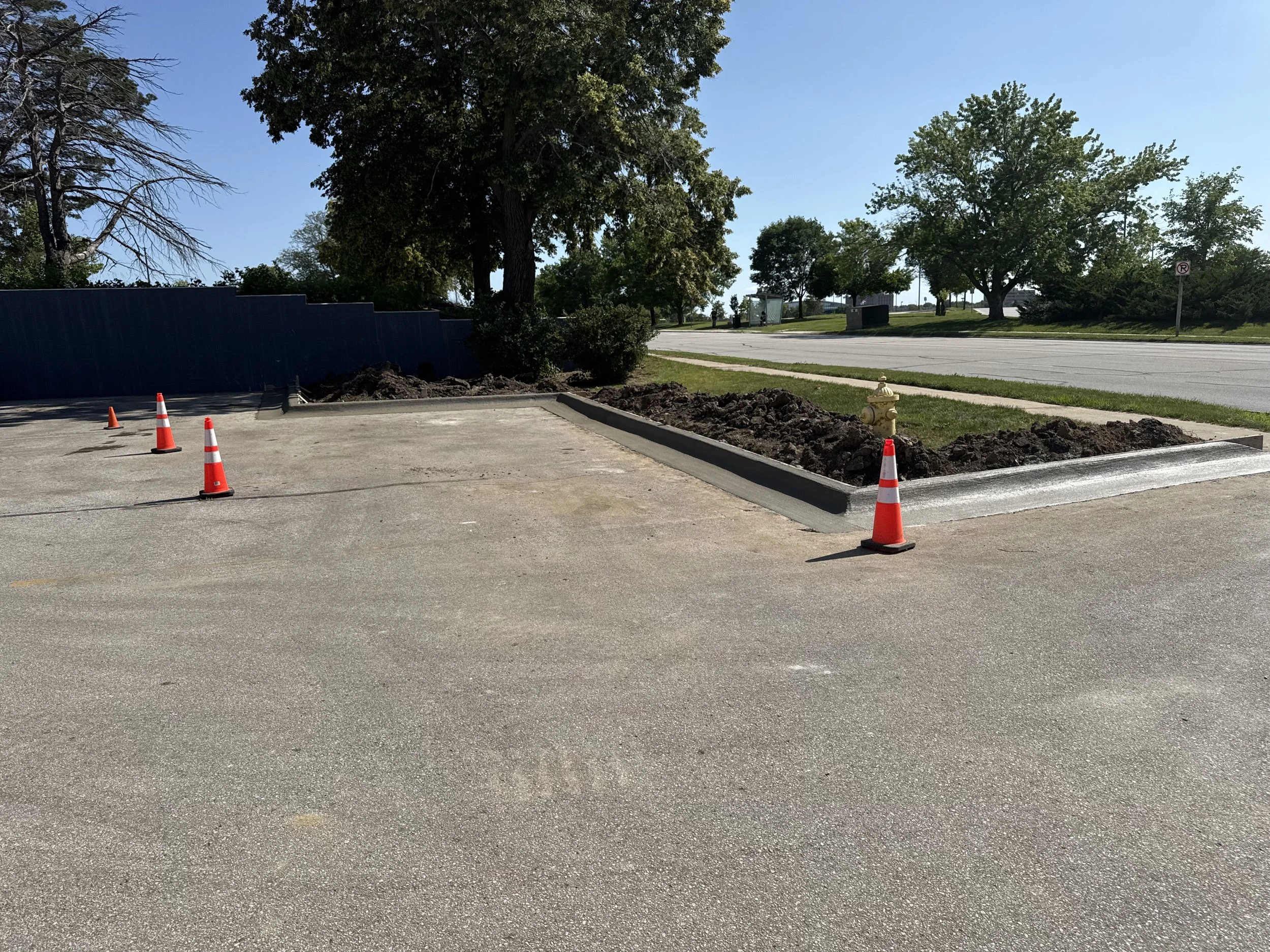 Wide, durable commercial entrance and parking area with expert curb-and-gutter installation in Urbandale.