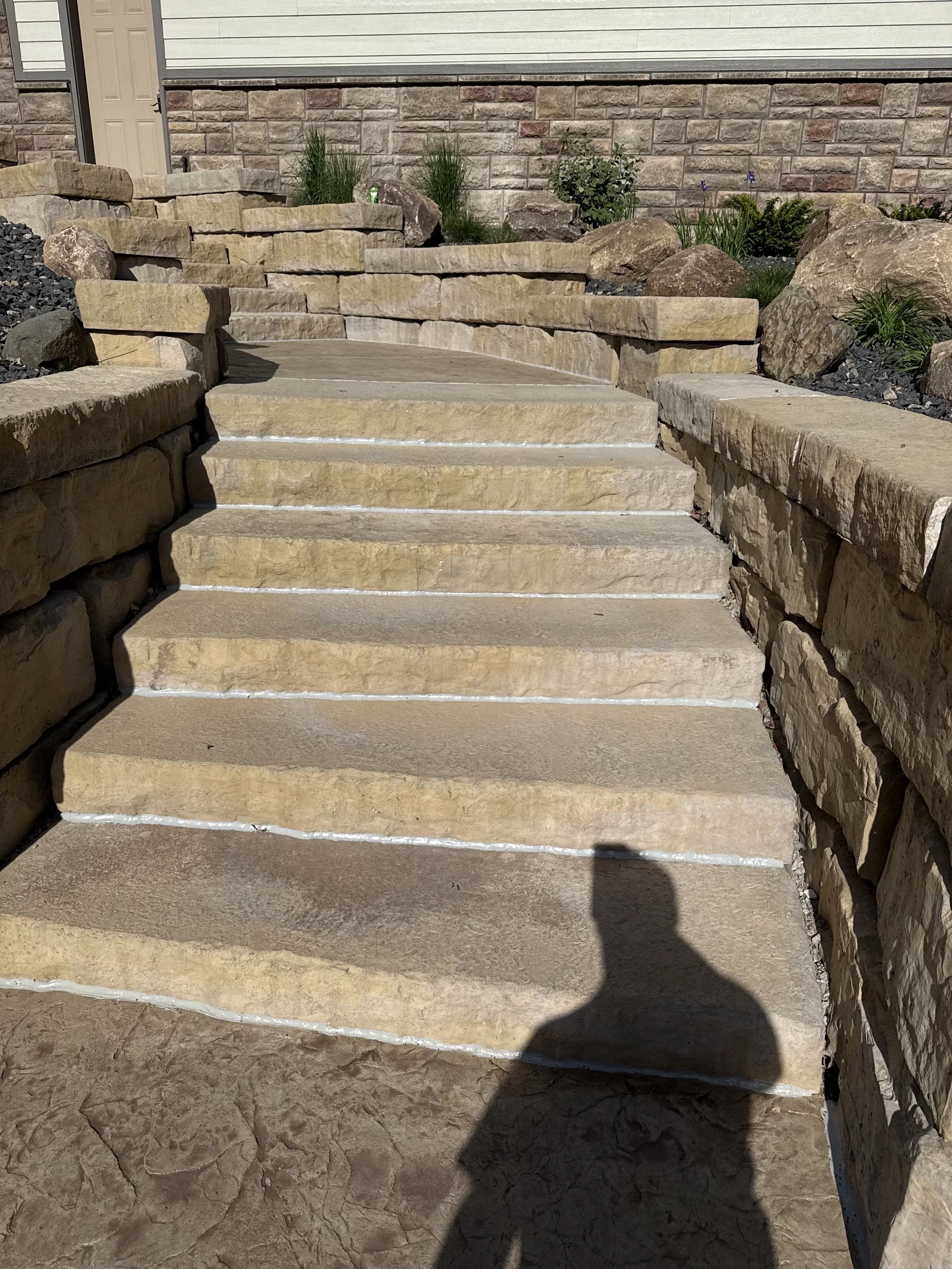 Freshly sealed concrete steps and seamless caulking job boosting curb appeal.