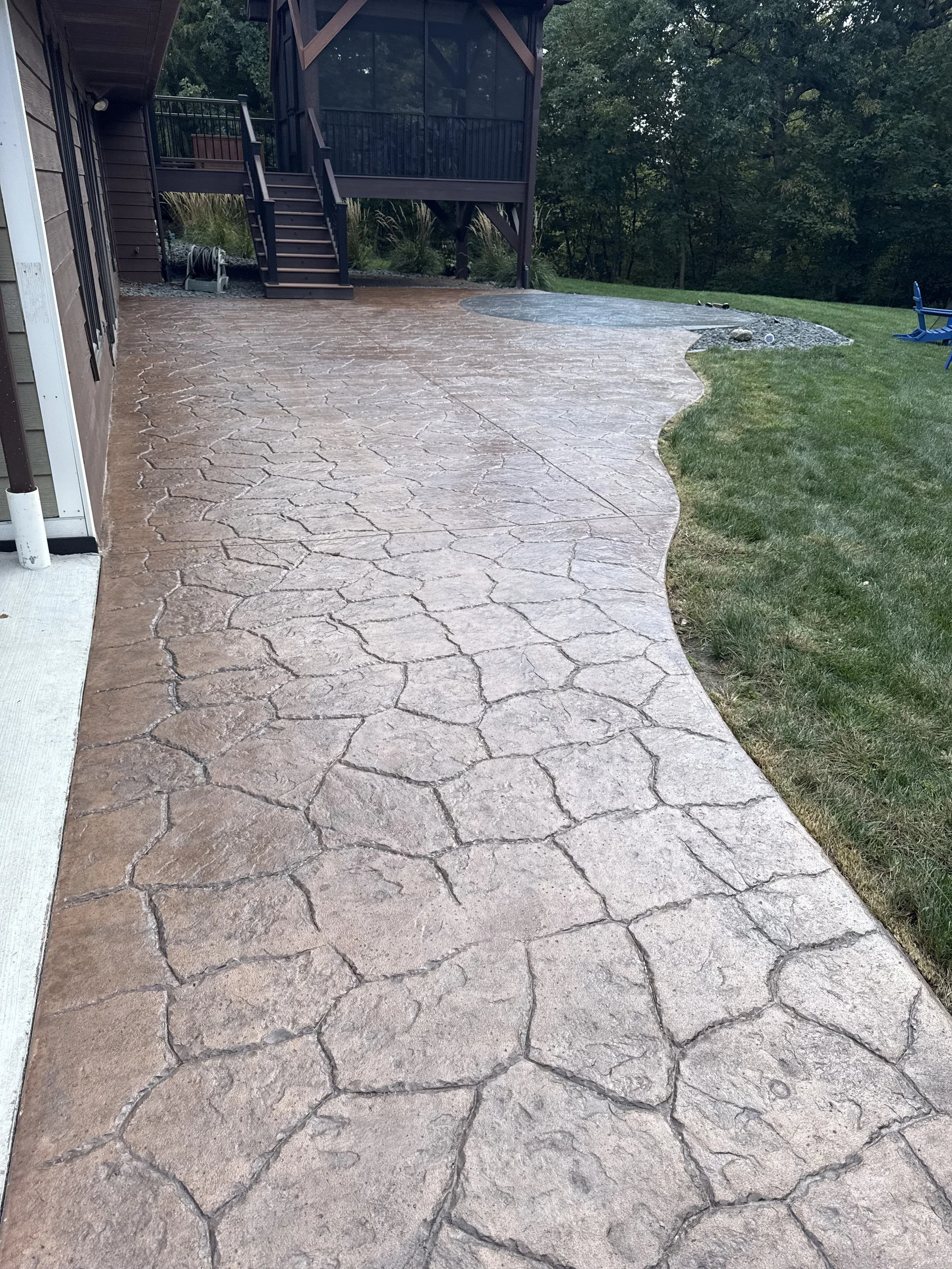 Freshly sealed stamped patio, boosting major curb appeal in Clive.