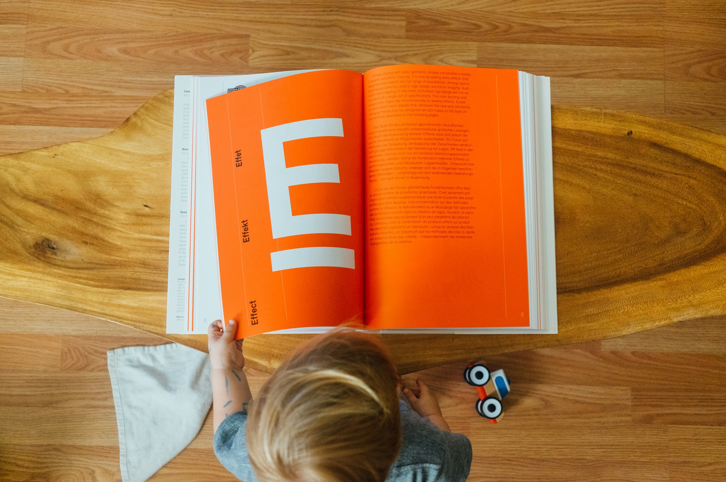 kelowna daycare preschool girl sitting on the floor reading a book